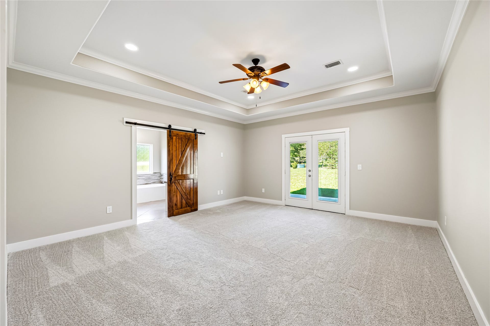 Fabulous Primary Bedroom with French Door to back patio & Barn door to En-Suite