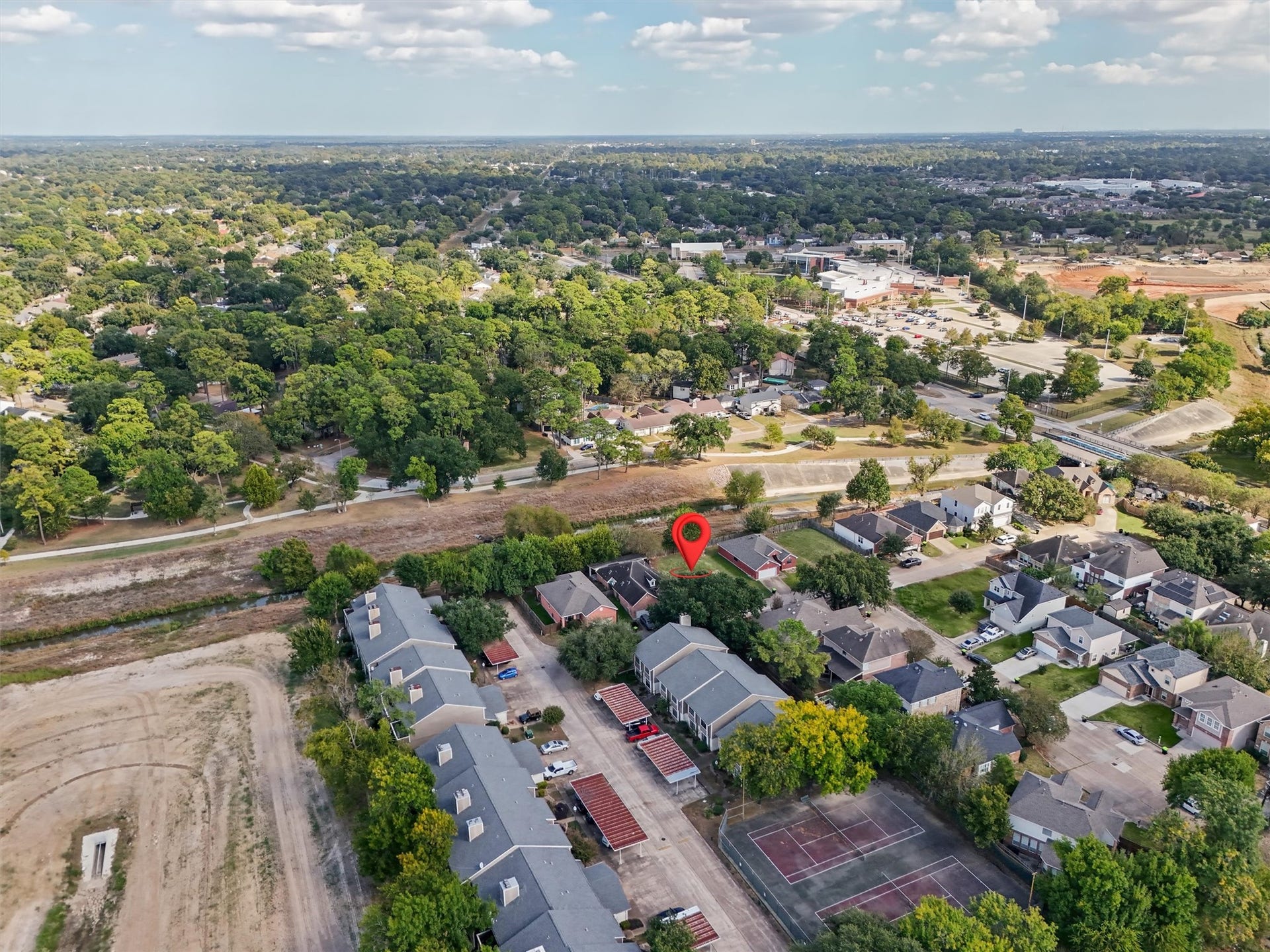 4444 Victory Dr, Houston, TX 77088 This cleared residential lot offers a wonderful opportunity to enjoy neighborhood living surrounded by mature trees, established homes, and nearby recreational amenities. The aerial view highlights the surrounding green spaces, walking paths, tennis courts, and nearby shopping and commercial areas. With convenient access to local roads and everyday essentials, this homesite offers a great combination of residential charm and accessibility. Your opportunity to build something special starts here!