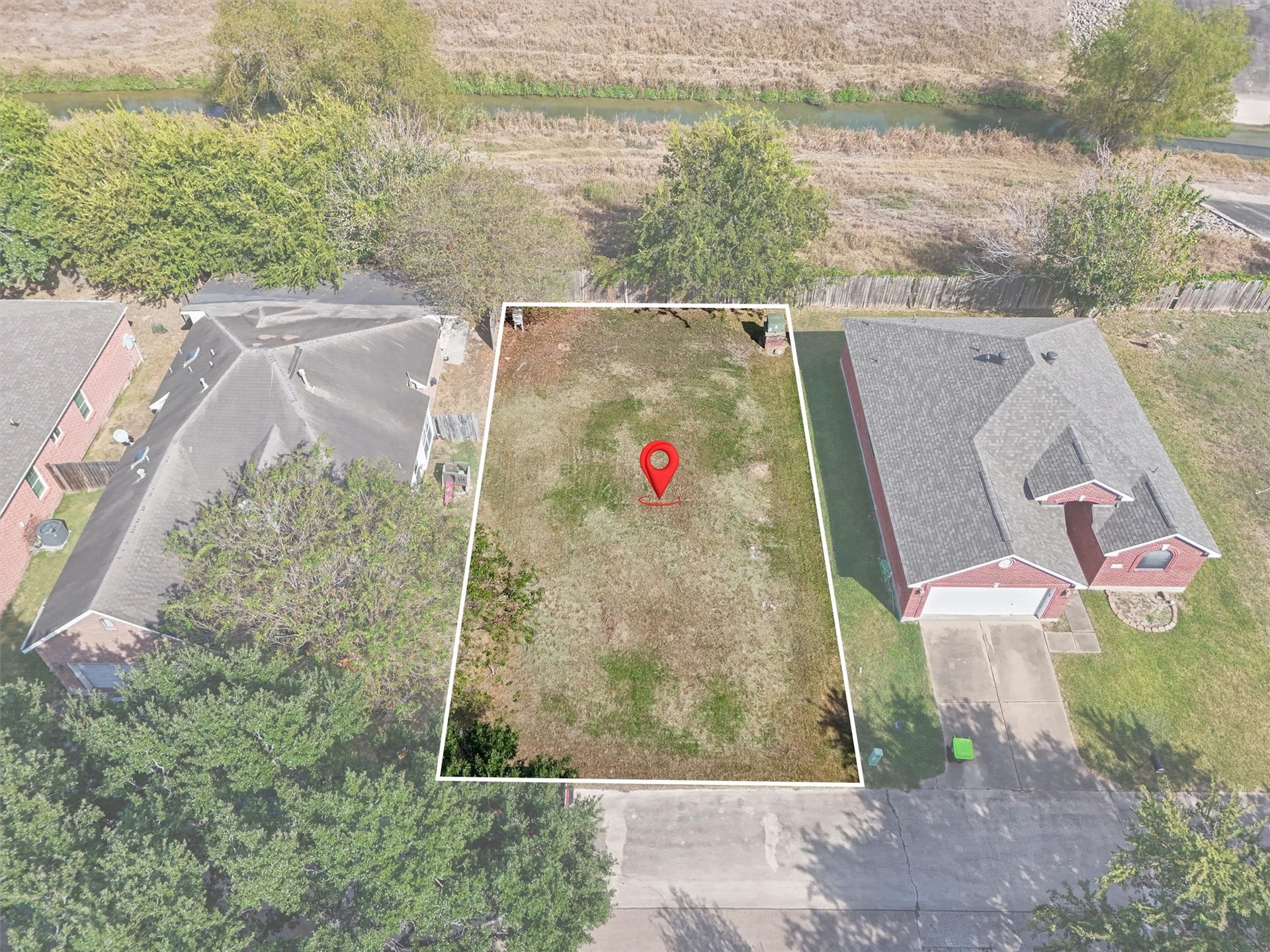 4444 Victory Dr, Houston, TX 77088 Your Dream Home Starts Here! The white outline highlights this spacious, cleared residential lot nestled between established homes. Imagine designing your custom dream home with room for outdoor living, a backyard retreat, and entertaining. Enjoy the charm of an established neighborhood with a greenbelt and waterway beyond the rear property line. A wonderful opportunity to build a home that fits your lifestyle!