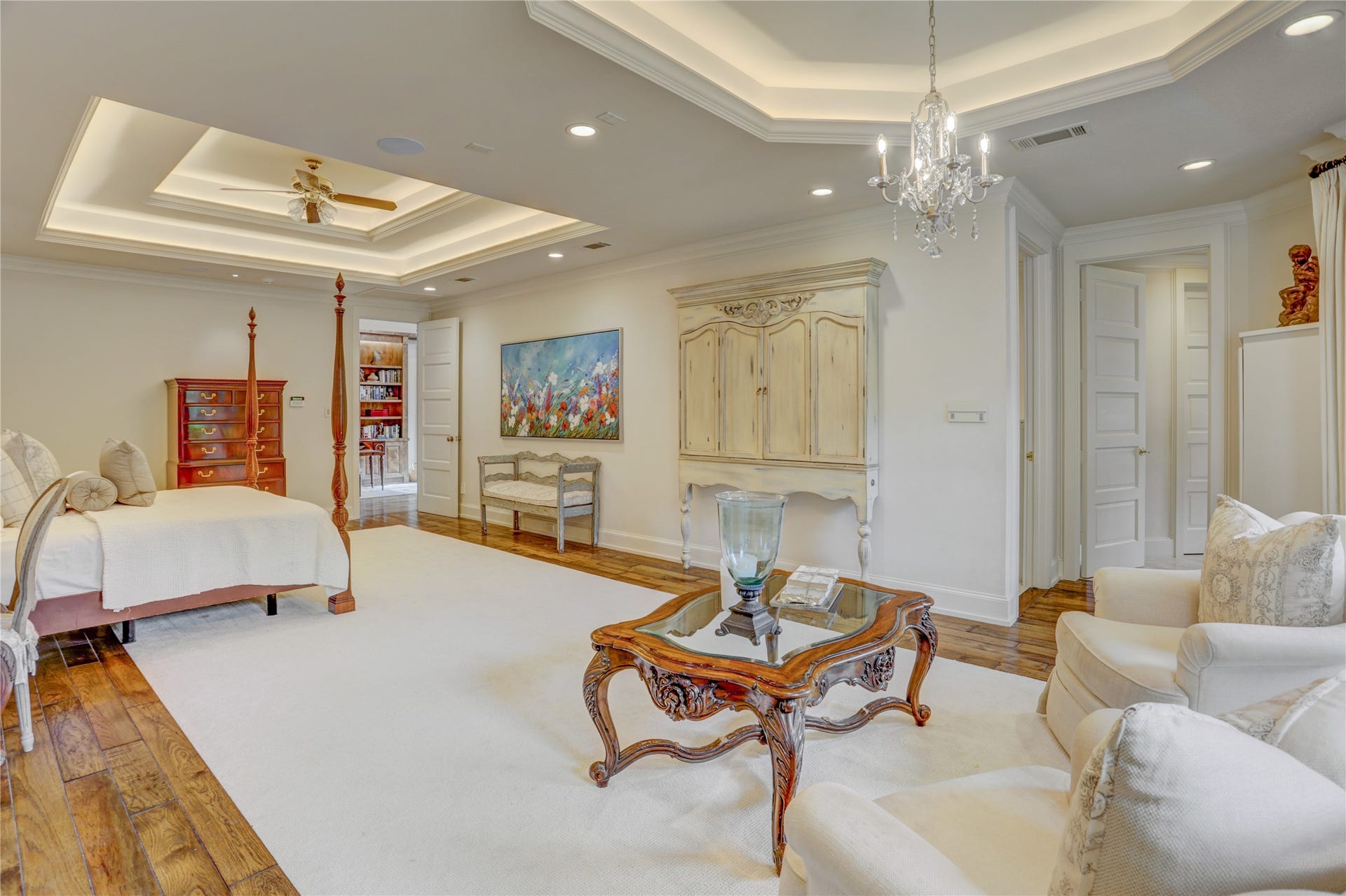 Another view of the primary suite from the seating area by the fireplace