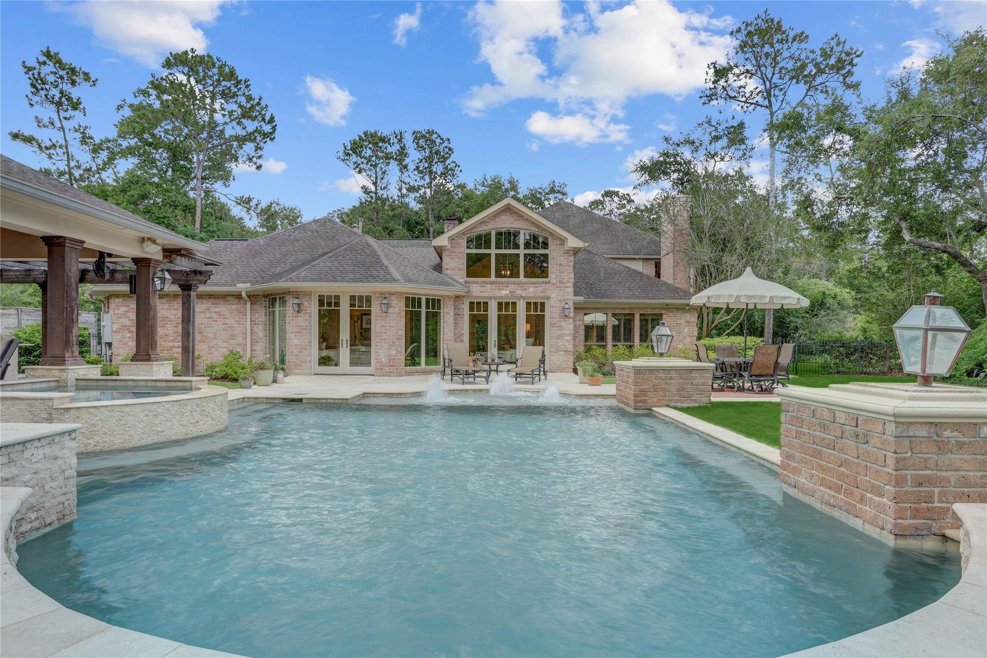 A view of the house from the waterfall at the end of the pool