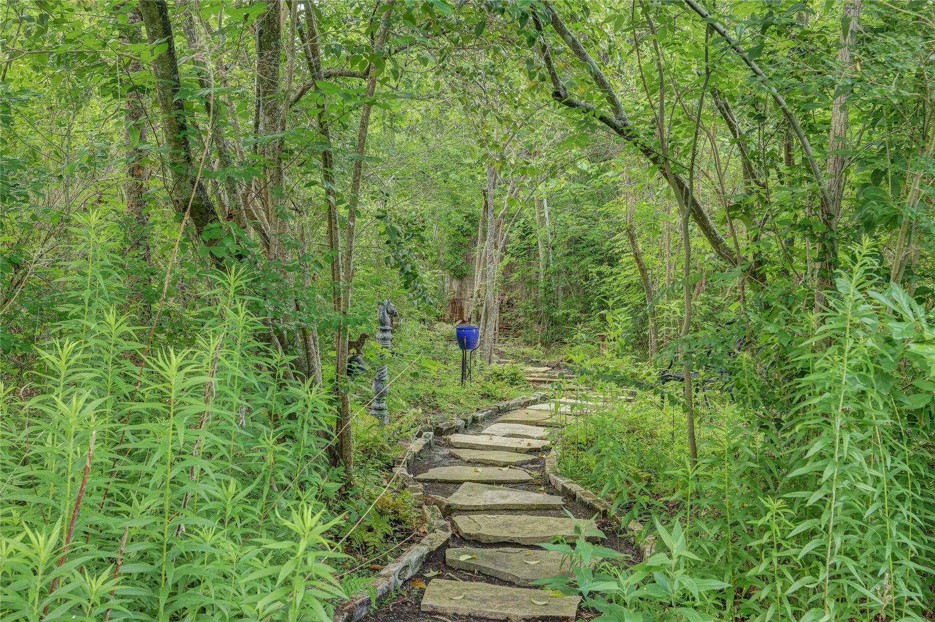 This magical path winds through the trees behind the pool an pavilion