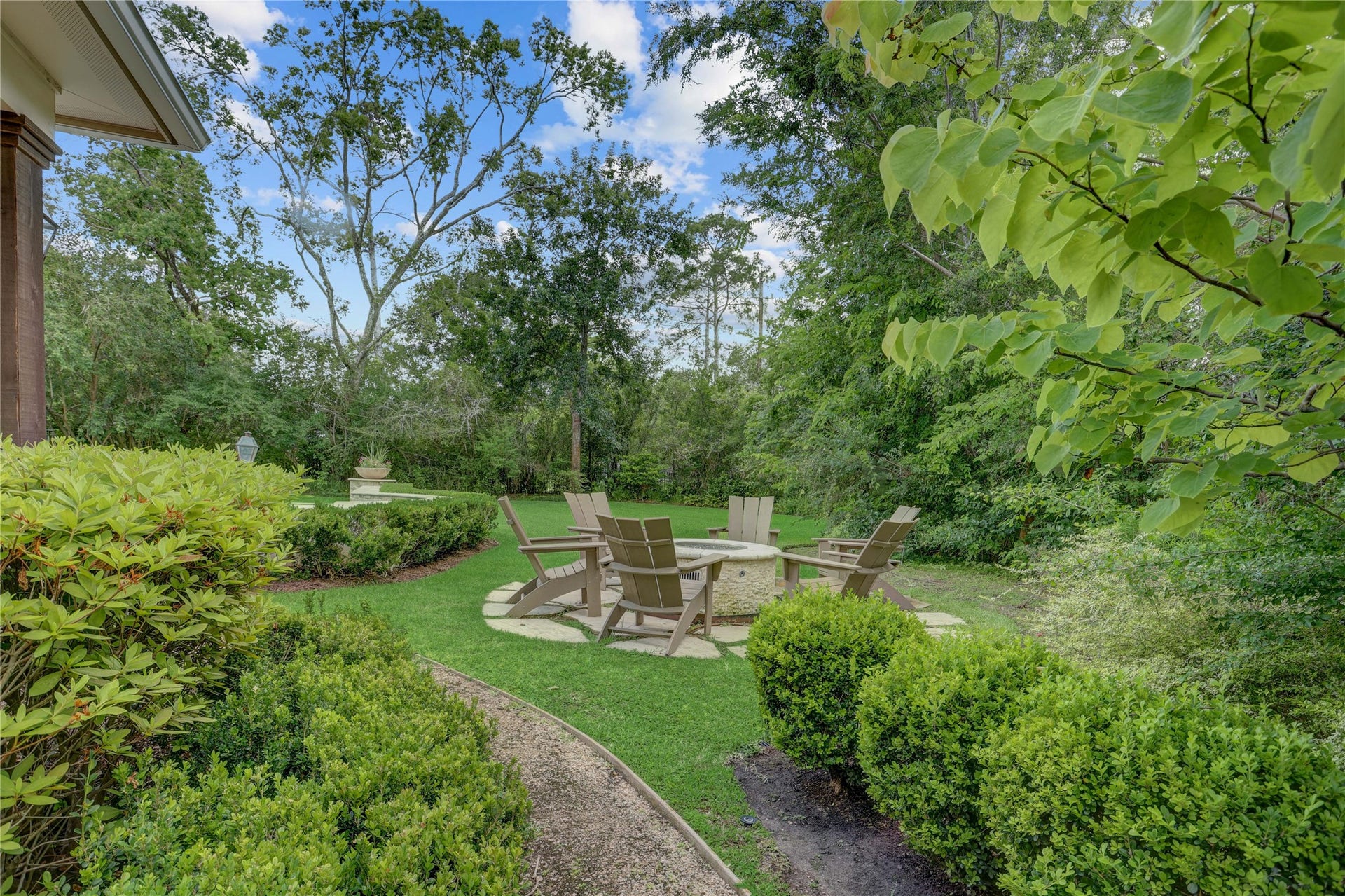 A view of the firepit from the end of the walkway through the trees