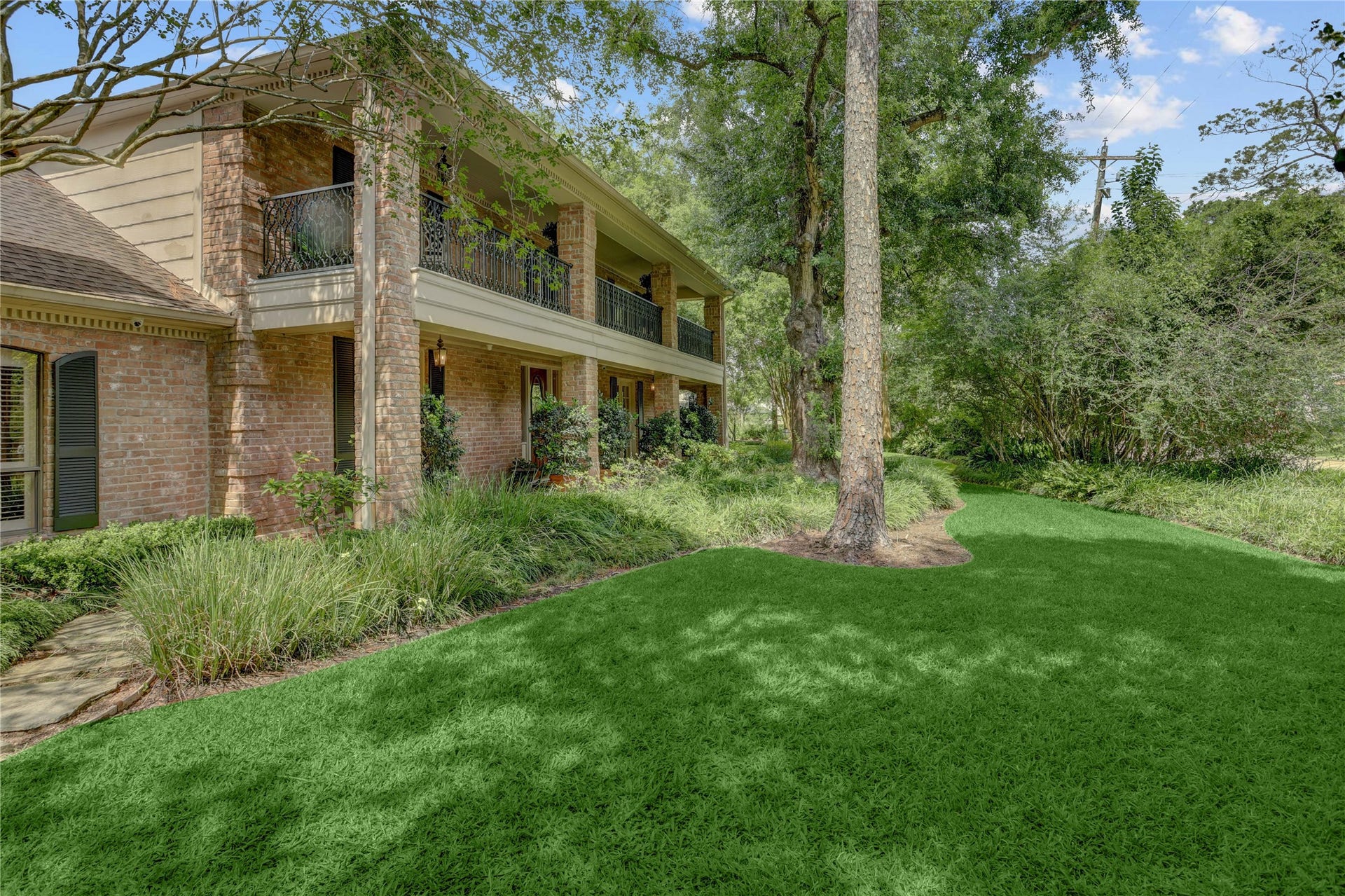 Gracious Charleston style home tucked in the heart of Piney Point Village, secluded behind mature shrubbery