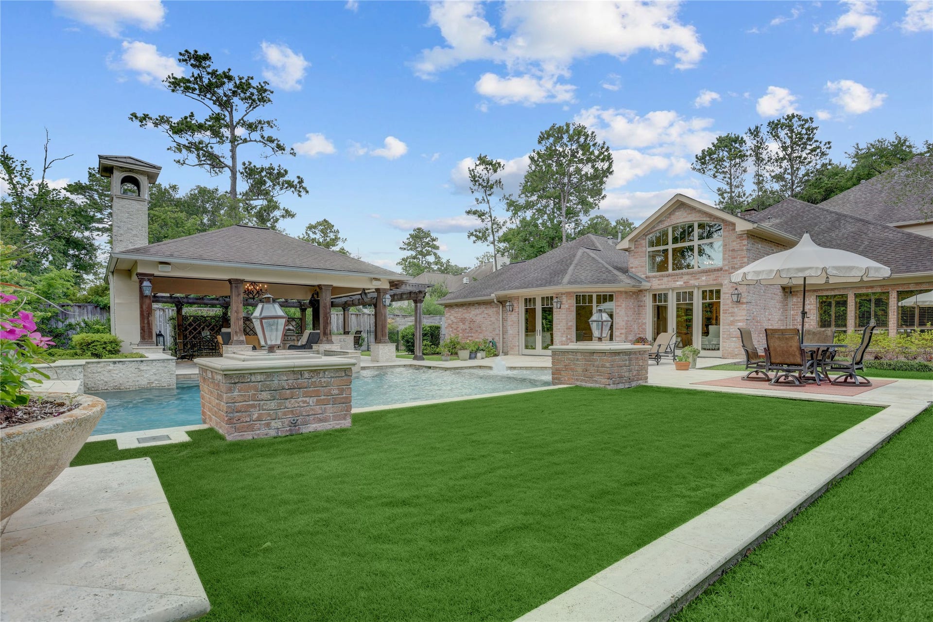 A view of the pool and pavilion from the manicured lawn