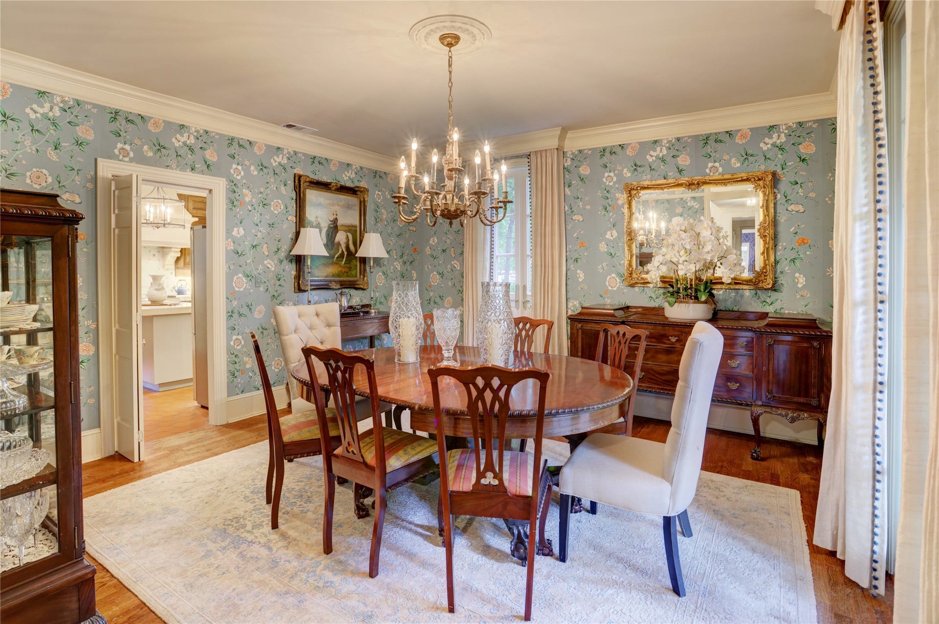Elegant dining room, hardwood floors, French doors overlooking the park-like front yard, hand-painted Gracie wallpaper and brass chandelier