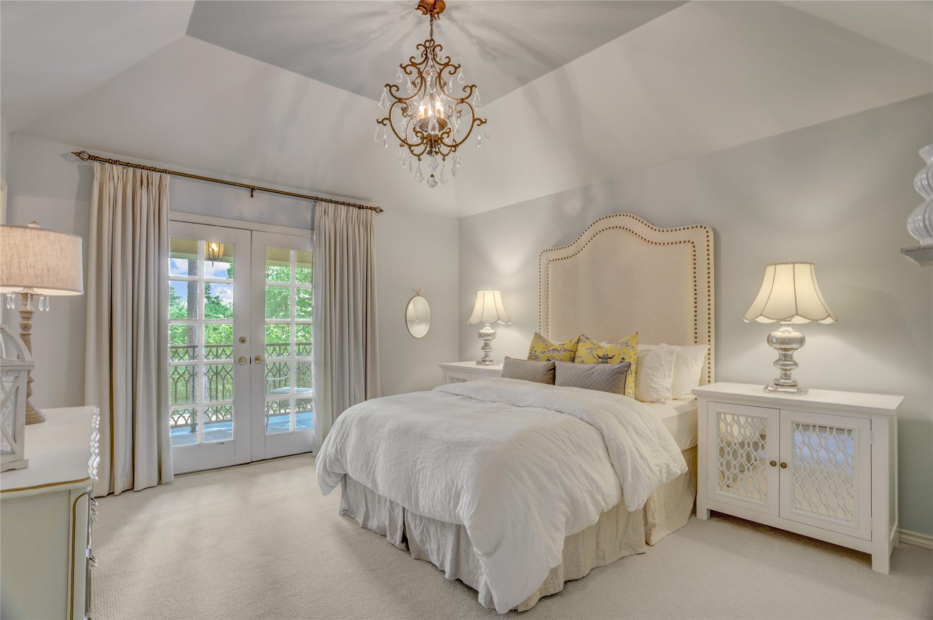 This secondary bedroom has a walk in cedar closet, and has French doors opening to the upstairs balcony