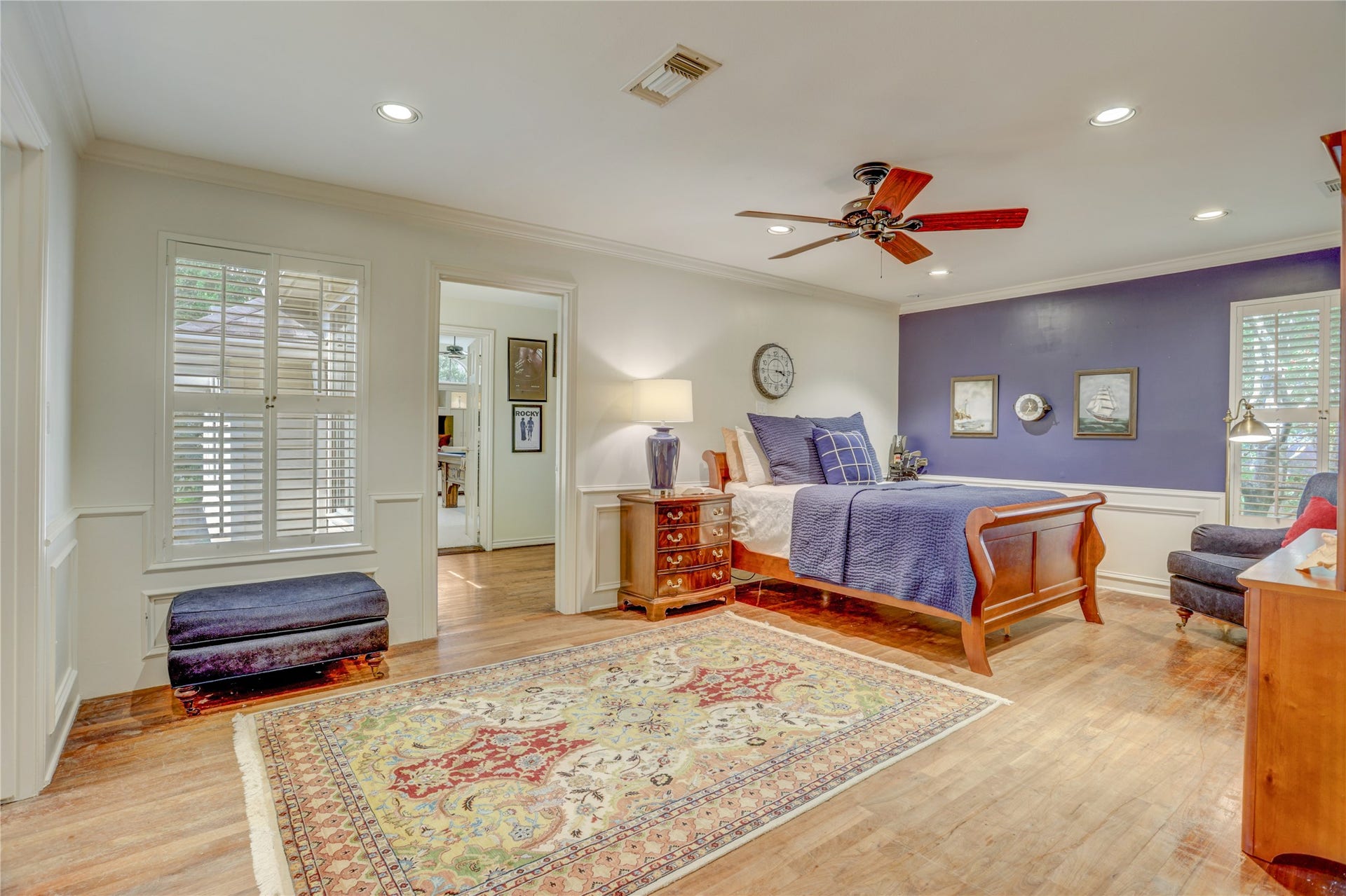 This secondary bedroom has hardwood floors and access to the third staircase and gameroom