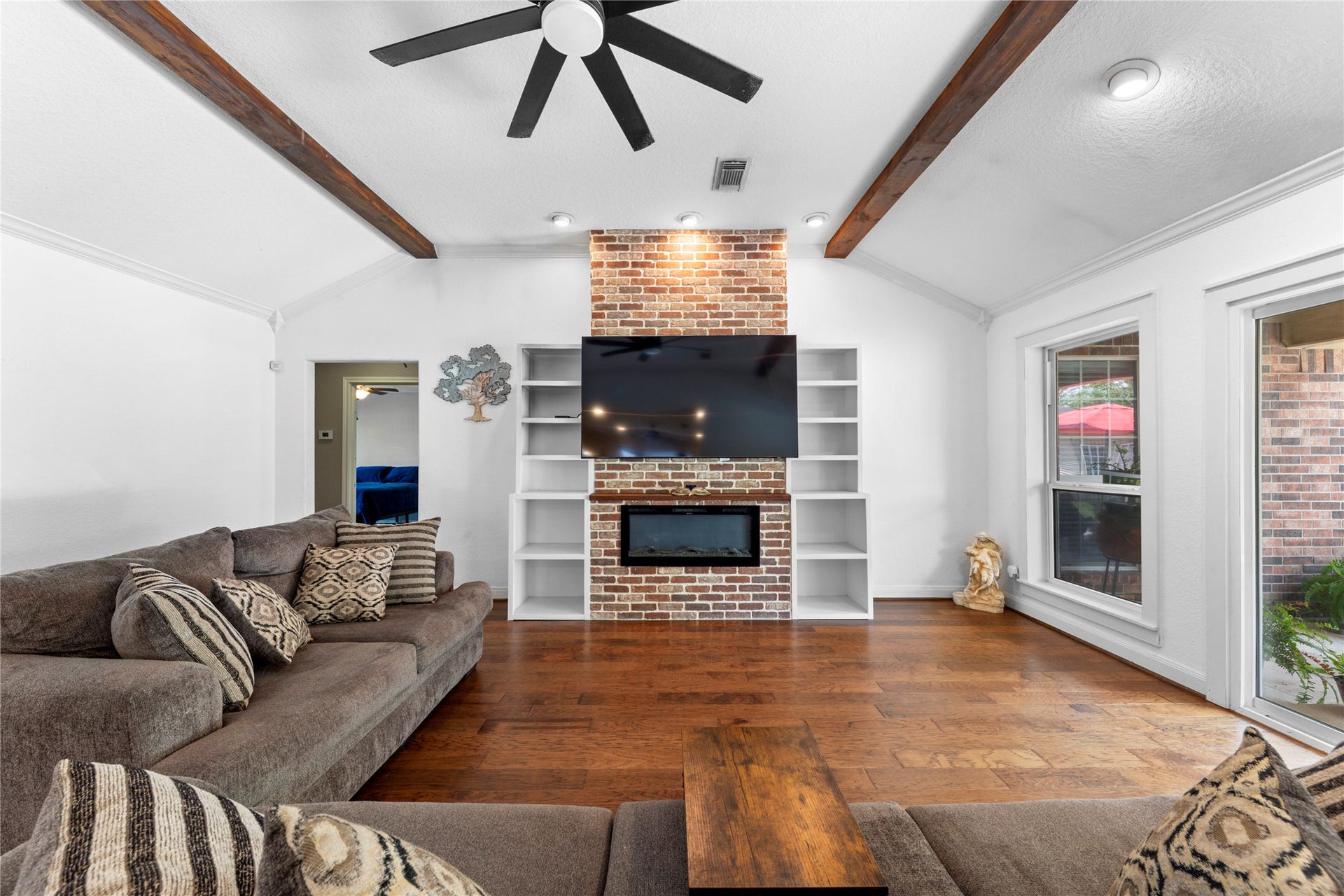 3430 W Meadow Lane, Dickinson, TX 77539 Glass fireplace and wood beams creates a great living space