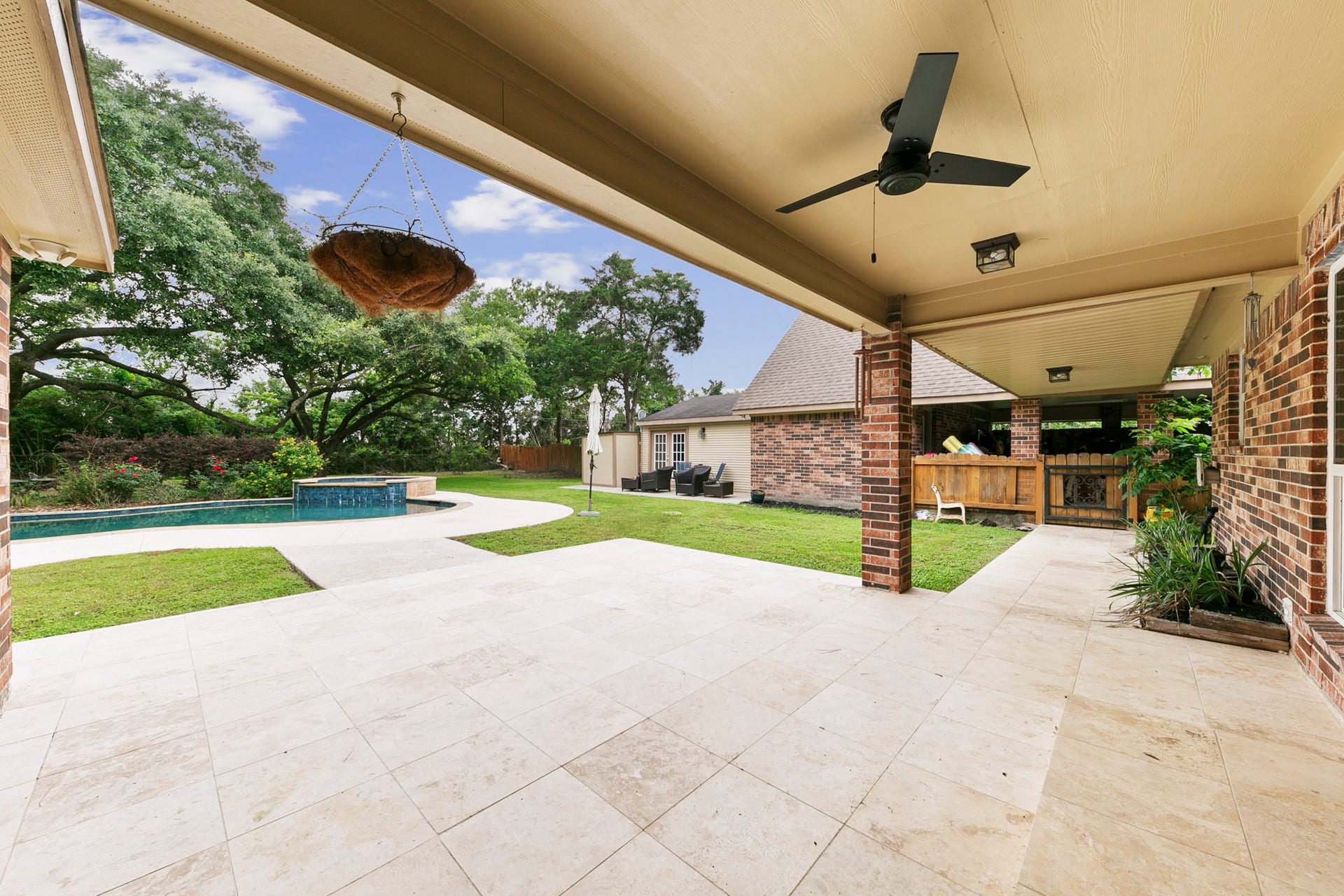 3430 W Meadow Lane, Dickinson, TX 77539 Oversized tile and covered porch overlooking pool area