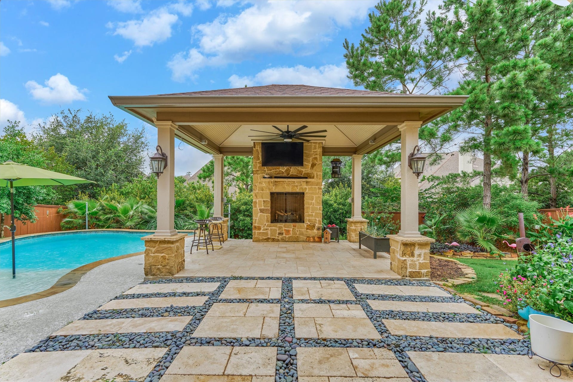 6 Canopy Green Drive, Tomball, TX 77375 pergola with fireplace, fan, and tv.