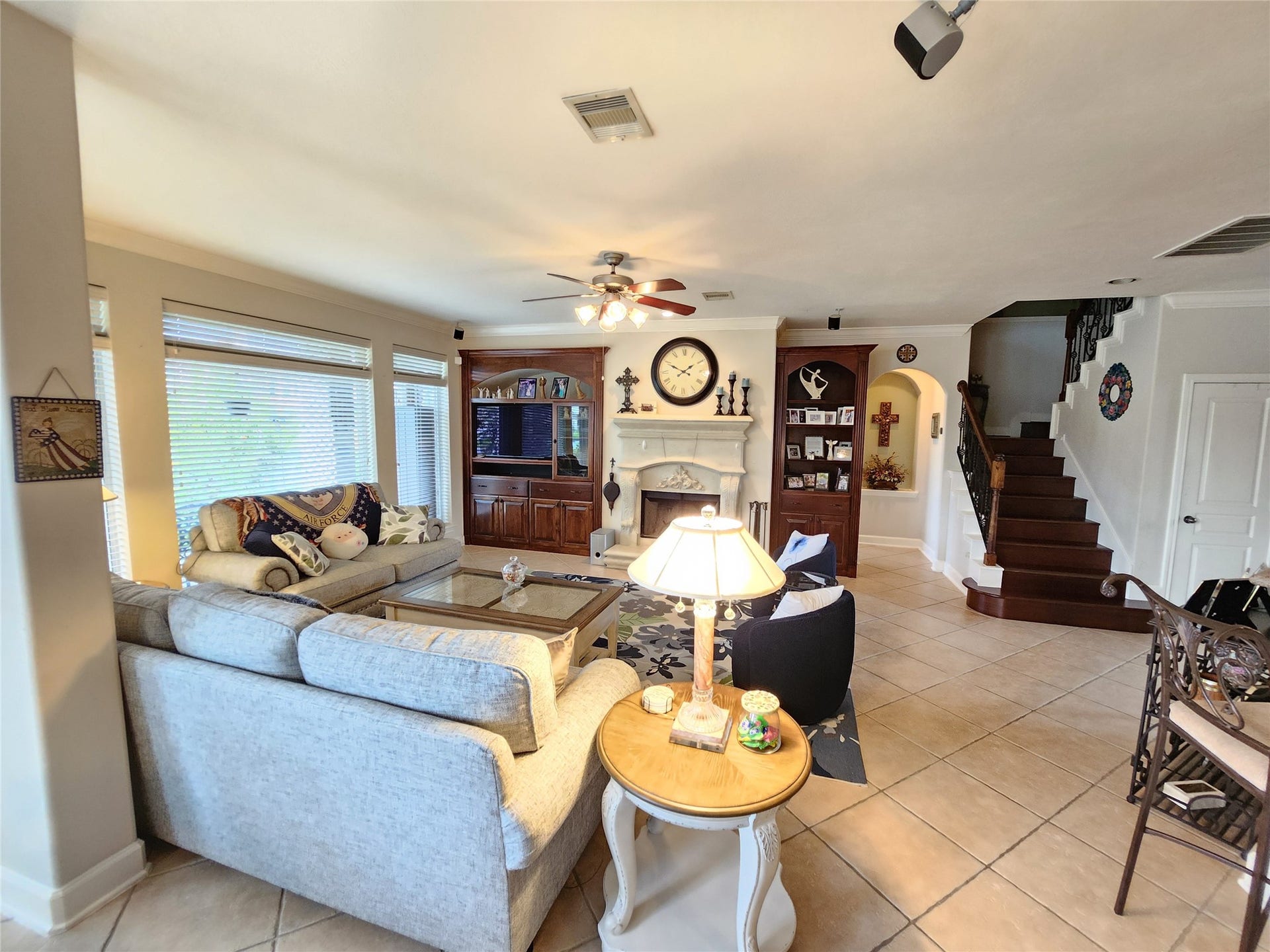 14330 Dunrobin Way, Sugar Land, TX 77498 Living area has a wall of windows featuring a water view. Notice the hardwood stairway to the upstairs bedrooms and game room.