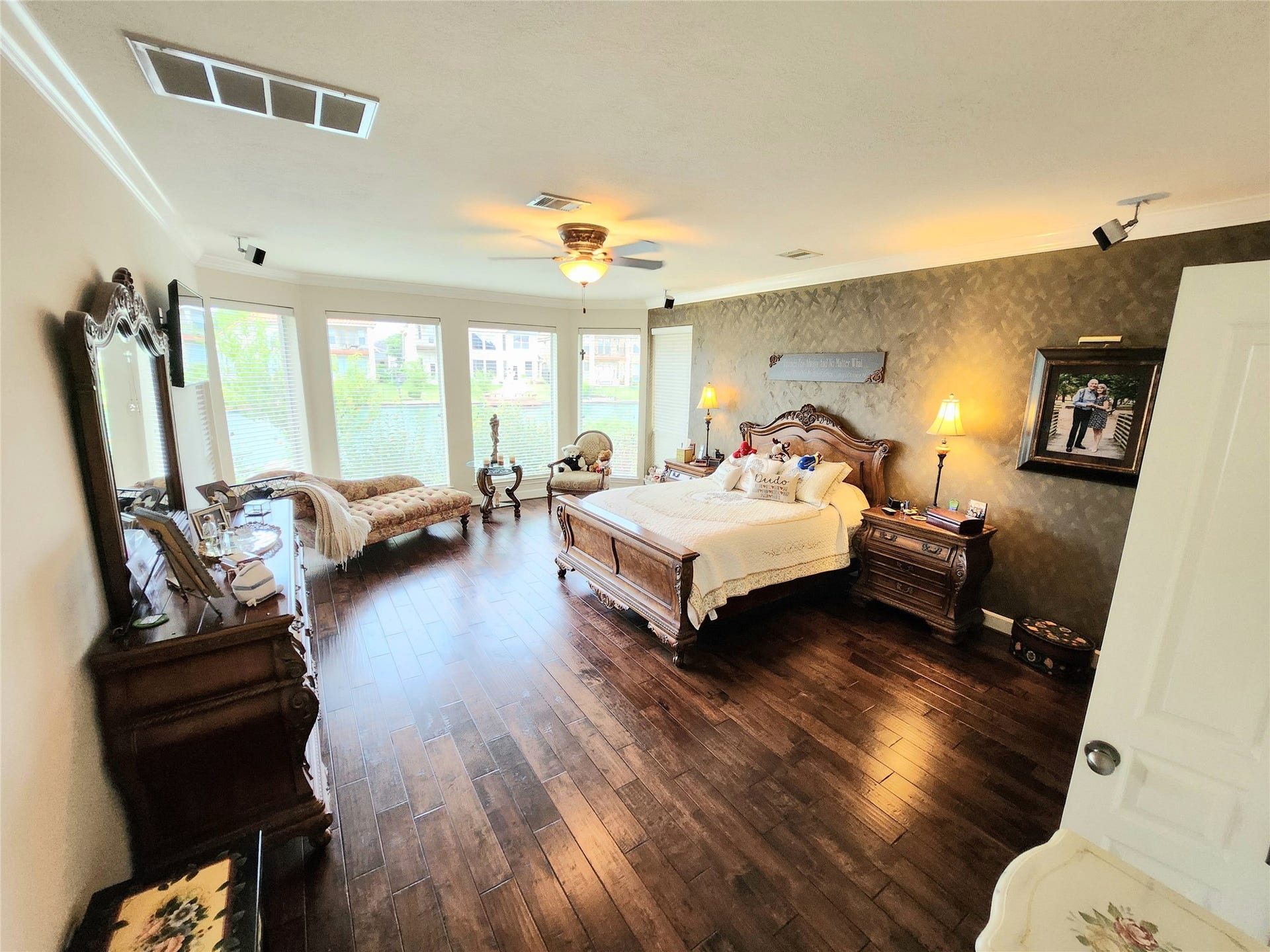 14330 Dunrobin Way, Sugar Land, TX 77498 The downstairs primary bedroom suite also has a wall of windows overlooking the water