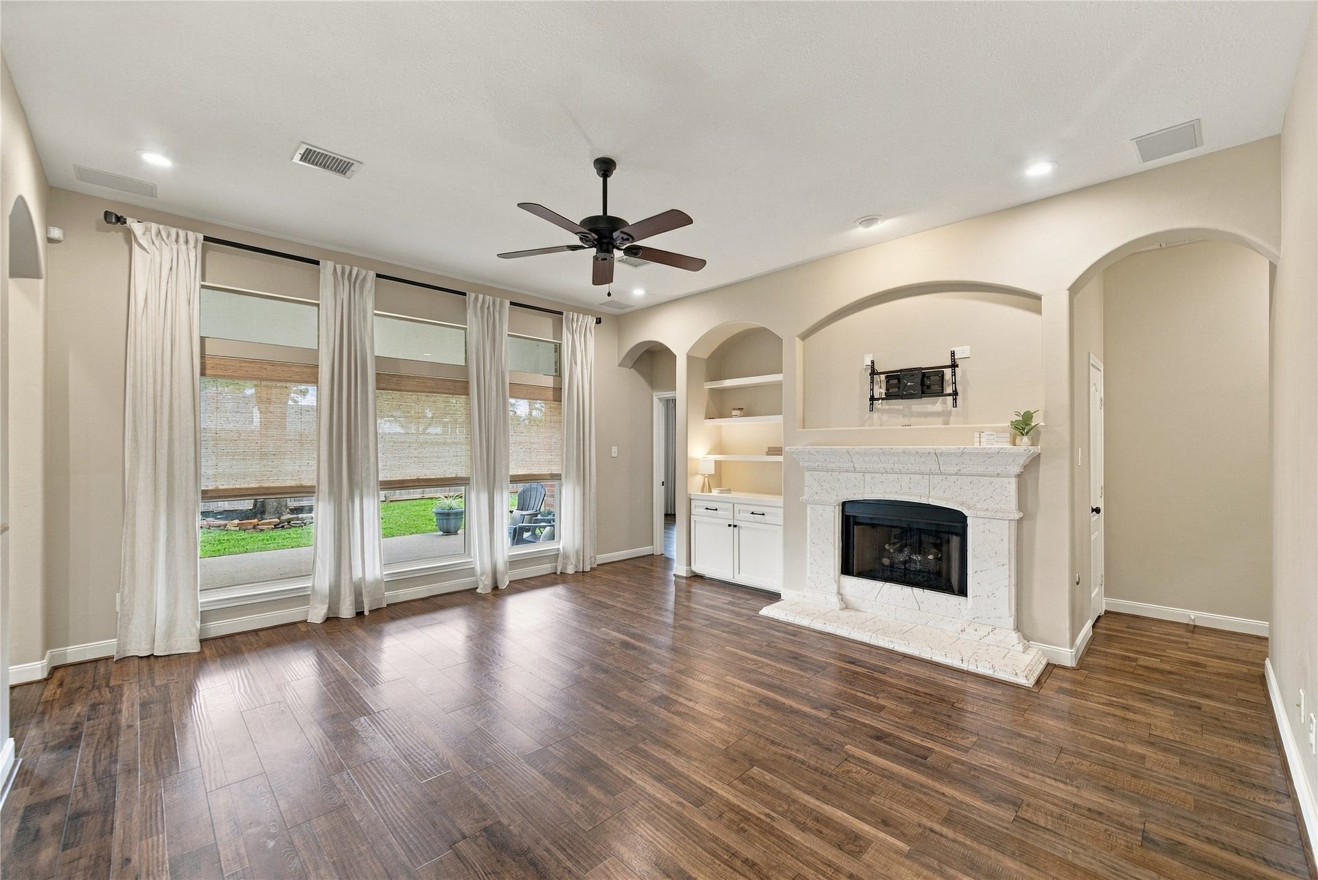 23706 Indian Hills Way, Katy, TX 77494 Step into this beautiful family room and you'll be impressed by its spaciousness, rich wood-look floors, elegant arched openings, built-in shelving, and inviting gas fireplace. What an attractive space for relaxing or spending time with family and friends!