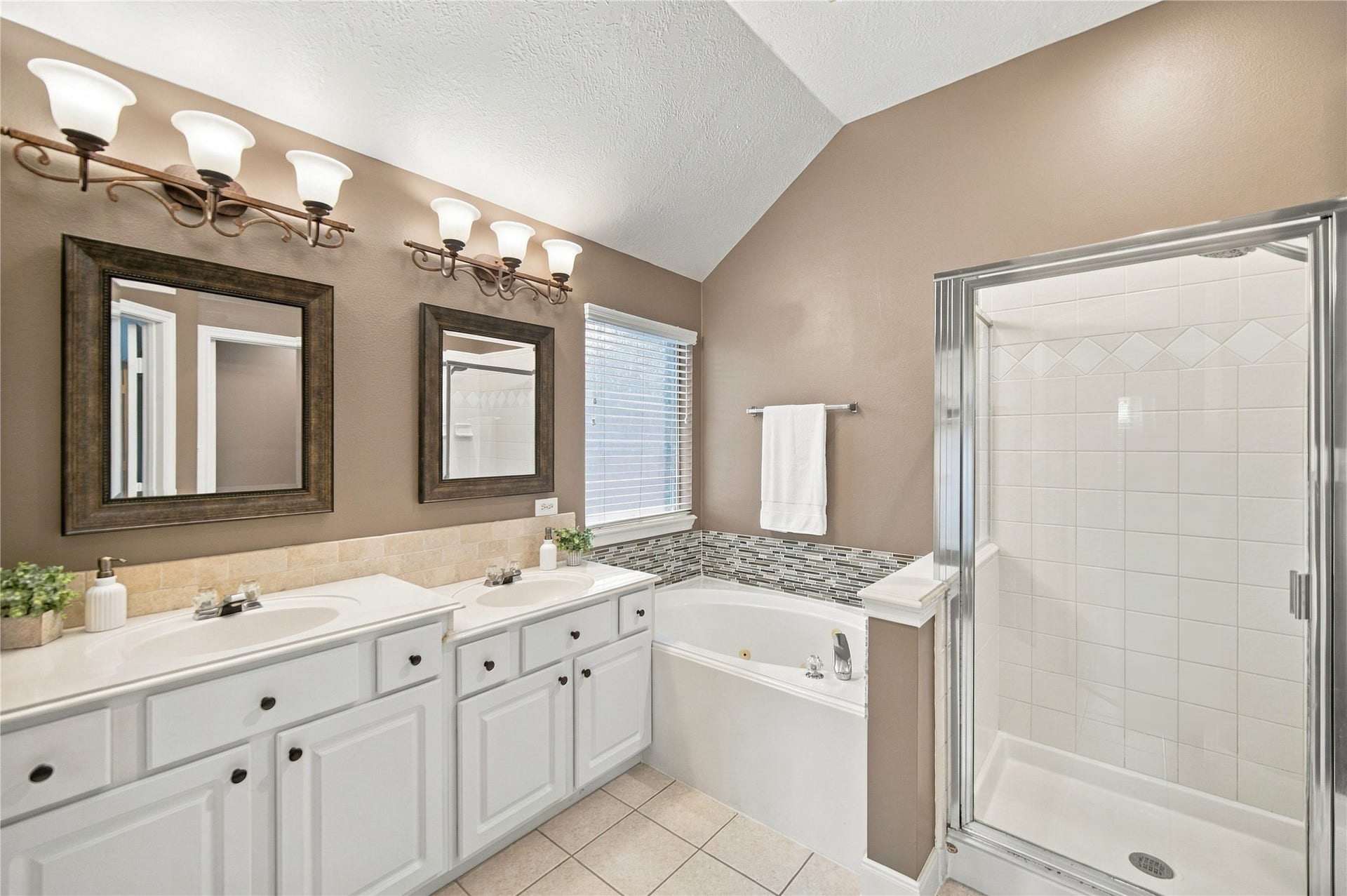 23706 Indian Hills Way, Katy, TX 77494 The primary bathroom provides a double-sink vanity, a jetted tub, and a walk-in shower.