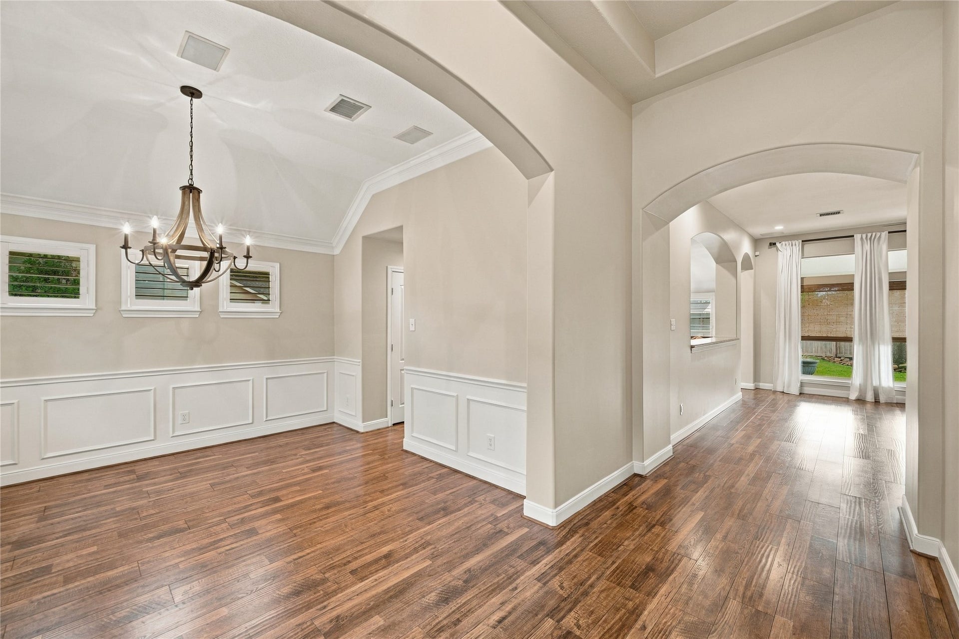 23706 Indian Hills Way, Katy, TX 77494 Enter the home and you will be met by gleaming wood-look floors throughout the main living areas, high ceilings, arched doorways, plus picture-frame molding in the formal dining room at left.