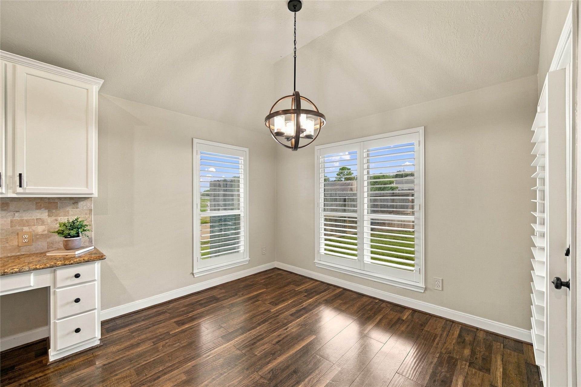 23706 Indian Hills Way, Katy, TX 77494 The kitchen flows seamlessly into the breakfast area and family room, creating an inviting space for everyday living and entertaining. At left is a very convenient built-in desk!