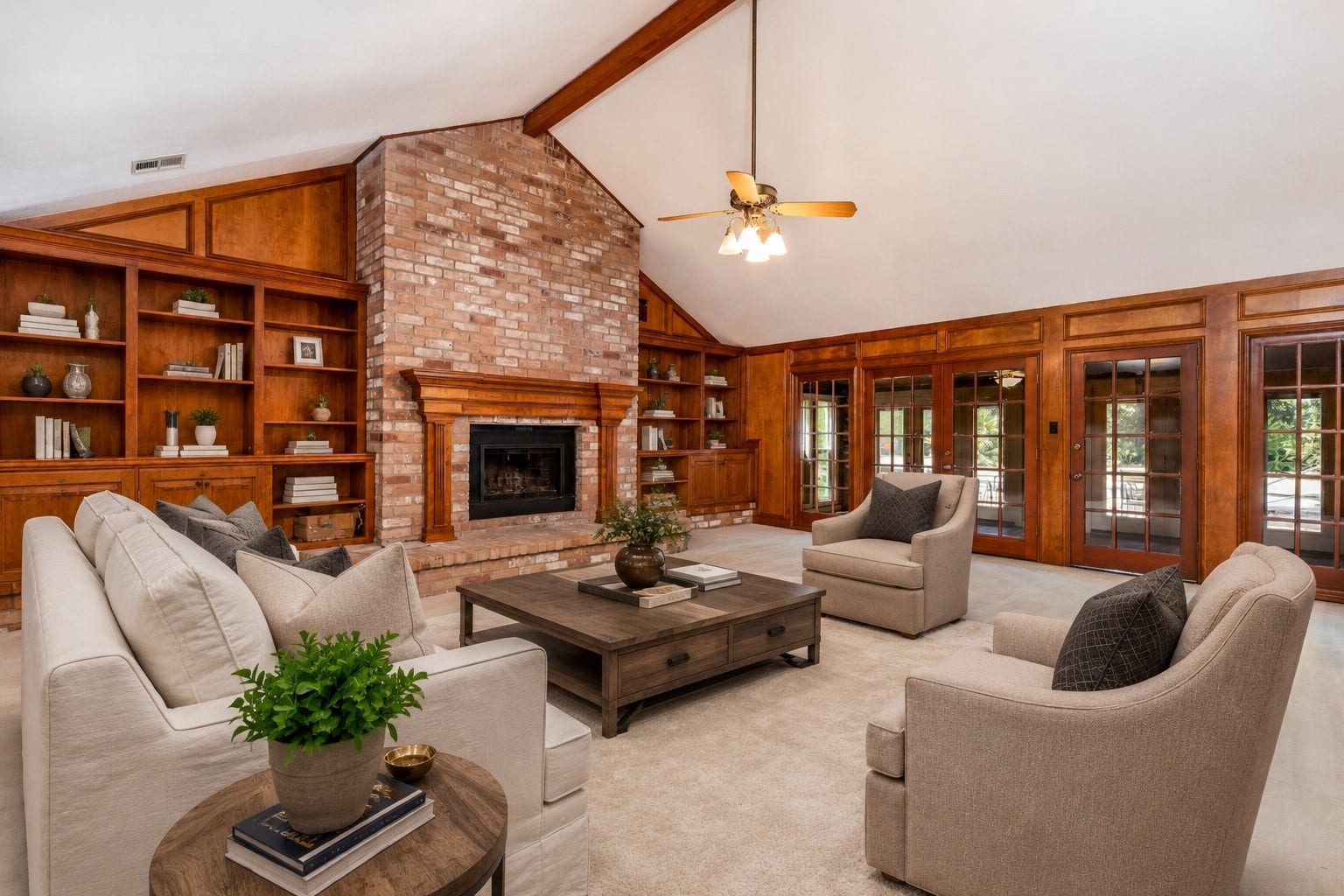 18926 Wildrose Lane, Tomball, TX 77377 The extra-large family room is designed to impress with soaring ceilings, rich custom wood paneling, and elegant molding that adds warmth and character. A fully bricked, wood-burning fireplace anchors the space, flanked by built-in bookcases that blend style with function. French doors open to a light-filled sunroom, extending the living space and creating an easy indoor-outdoor flow. A tucked-away dry bar makes this the perfect room for gatherings, game nights, or relaxed evenings at home.