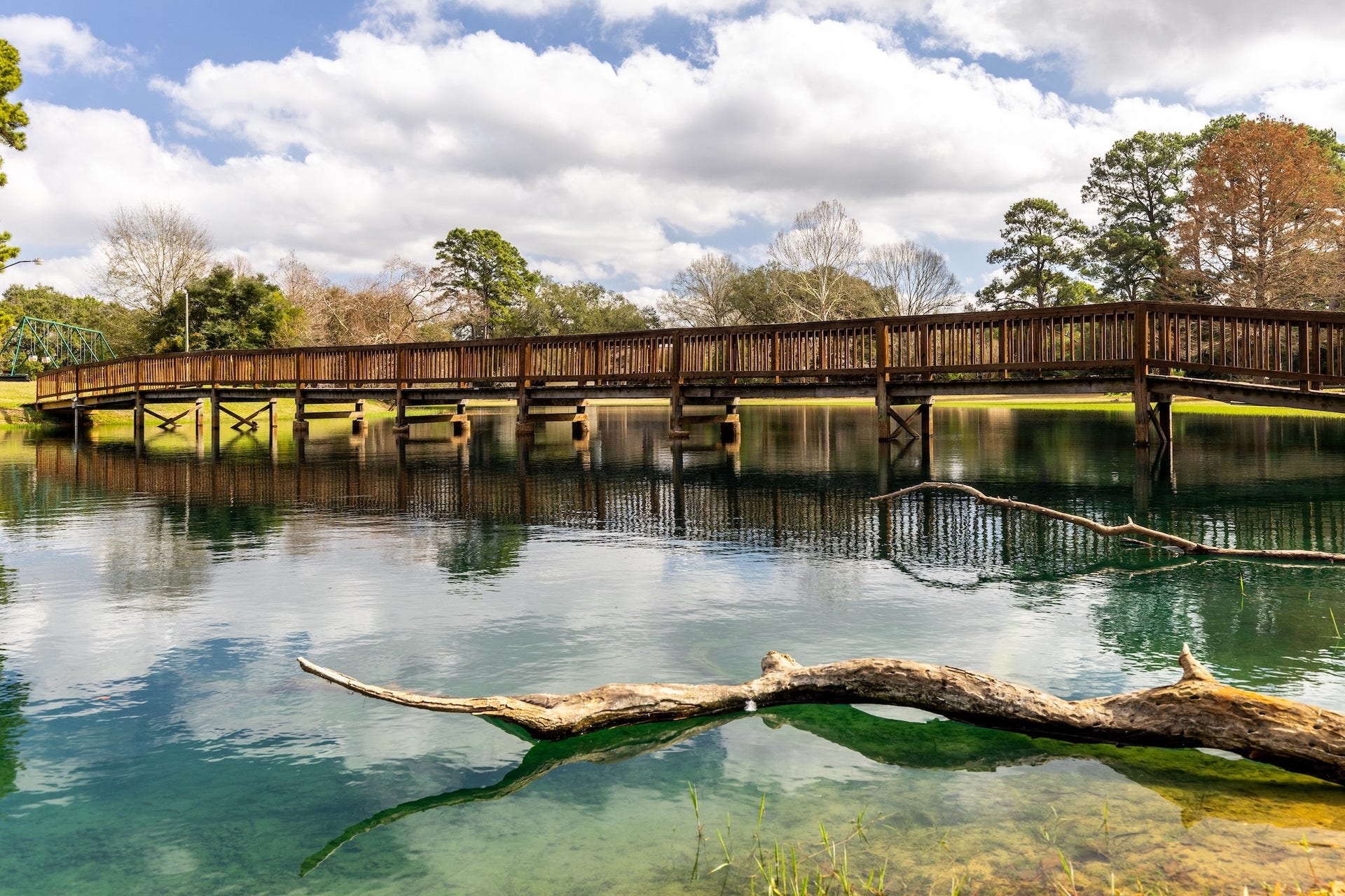 18926 Wildrose Lane, Tomball, TX 77377 The nearby pond is perfect for catch-and-release fishing, offering a peaceful retreat surrounded by nature. A charming wooden bridge crosses to the other side, creating a serene spot to relax or take family pictures!