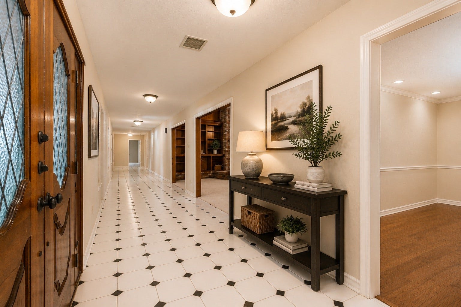 18926 Wildrose Lane, Tomball, TX 77377 A bright, welcoming entryway with striking white tile floors accented by black details. Sunlight pours in through the windows, creating a warm, inviting atmosphere. The long walls offer the perfect gallery space to showcase your artwork and personal style. Digitally Staged