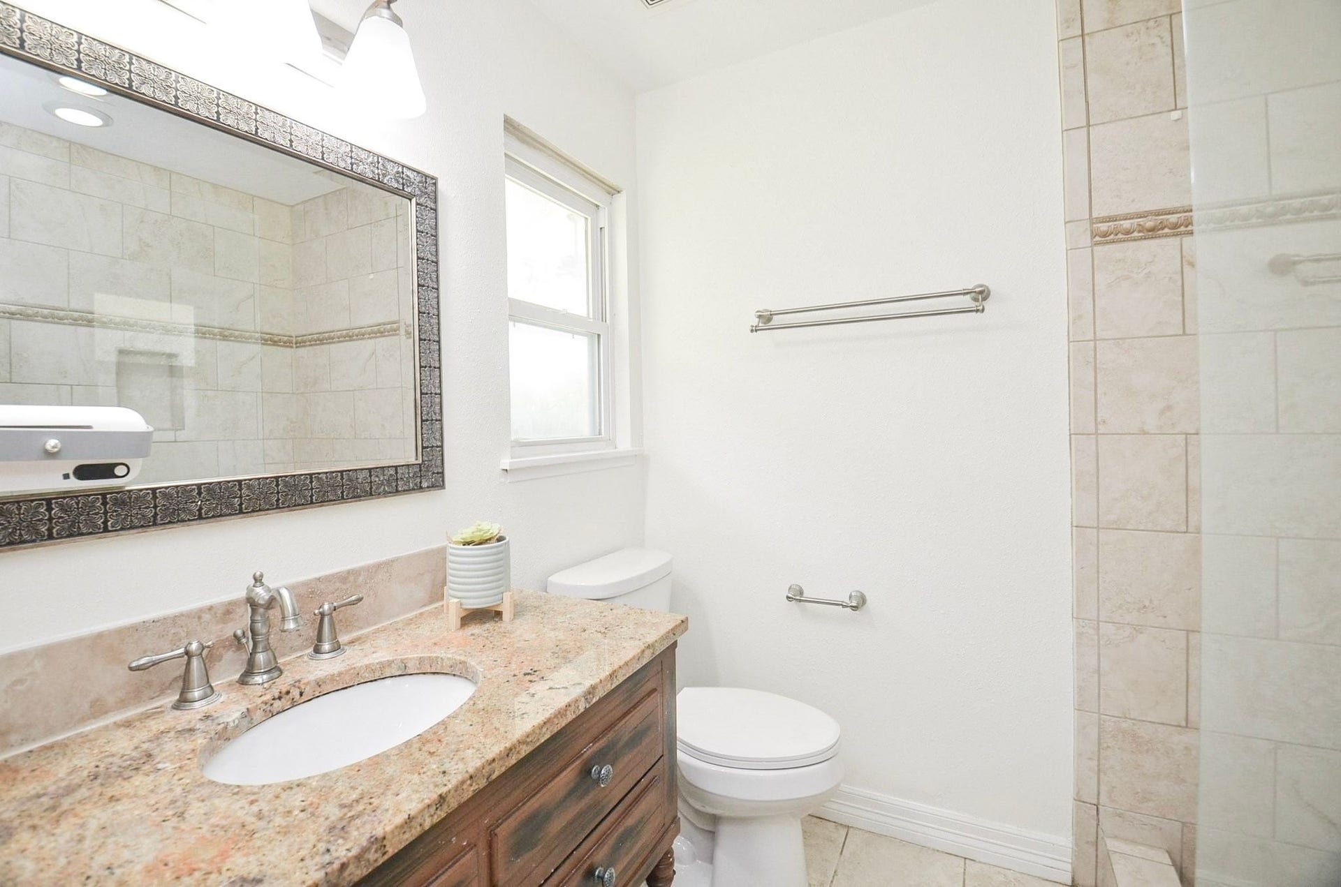 5515 Saxon Drive, Houston, TX 77092 Primary suite with walk-in shower and brushed nickel faucet.