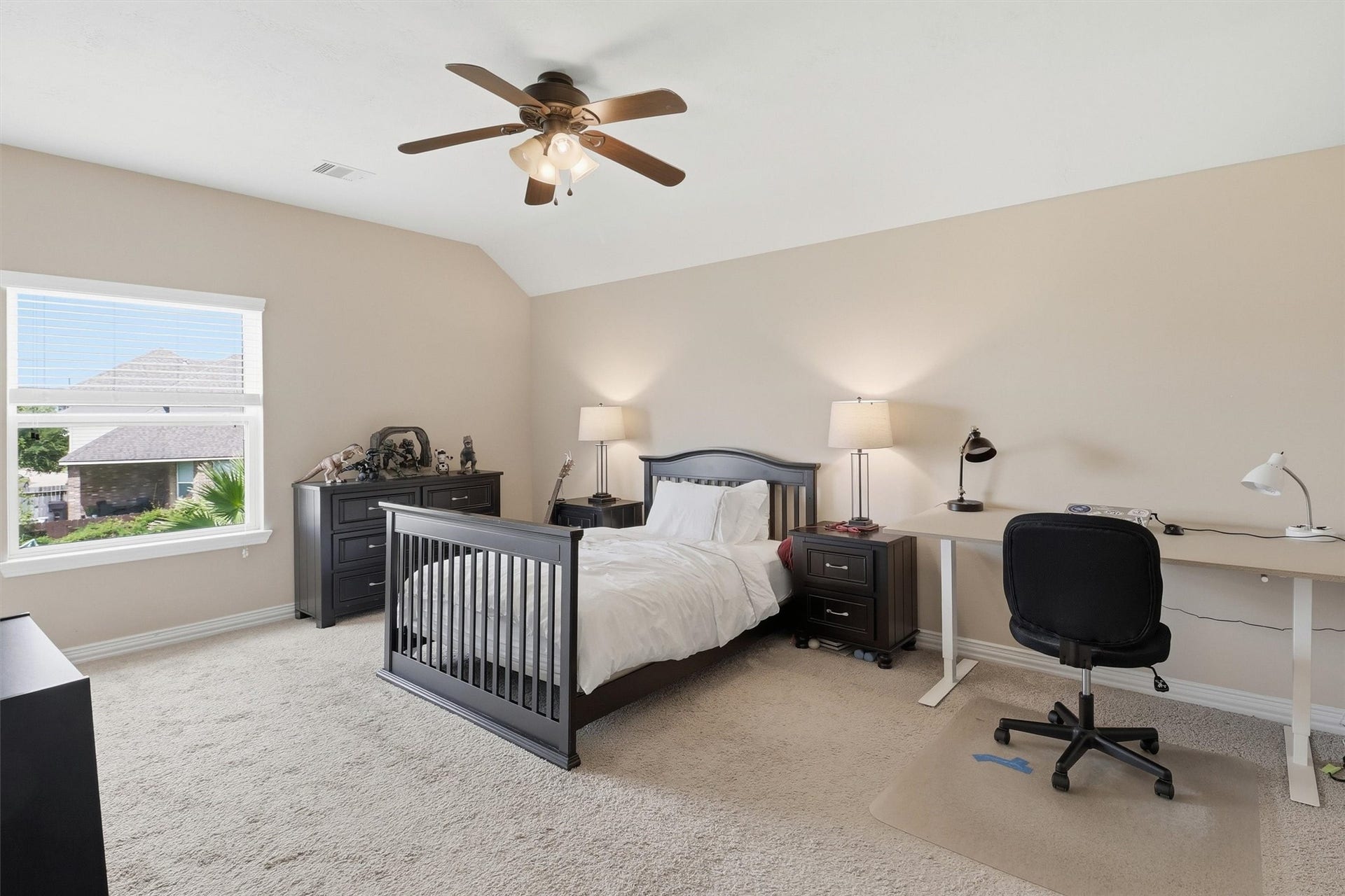 3219 Cotton Ranch Drive, Katy, TX 77494 This spacious secondary bedroom features plush carpeting, abundant natural light, and plenty of room for a full bedroom suite or study area.
