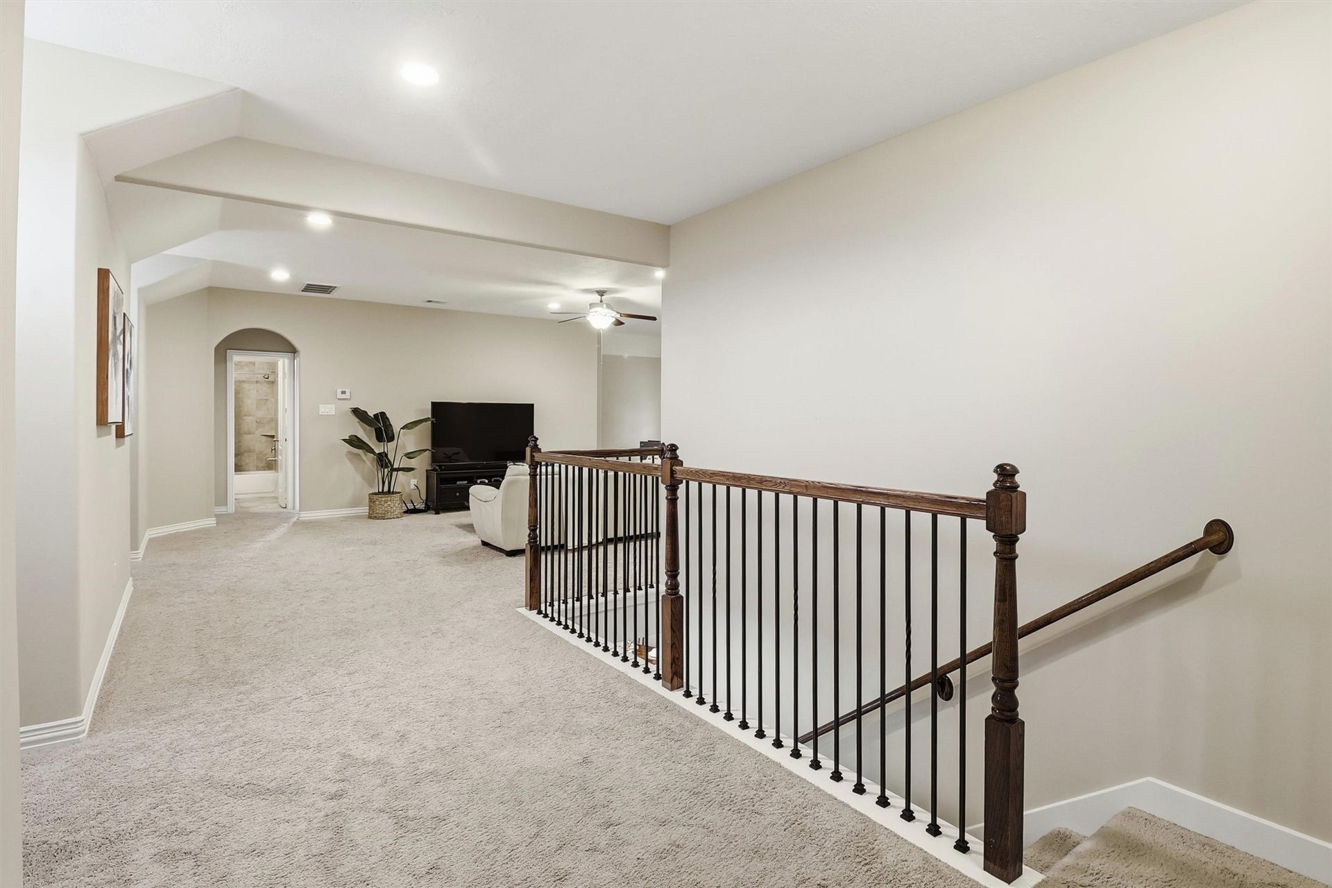 3219 Cotton Ranch Drive, Katy, TX 77494 Discover the expansive upstairs landing, complete with wrought iron spindles, plush carpeting, and flexible space that connects the game room and secondary bedrooms.
