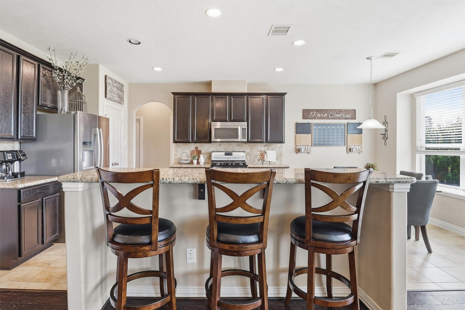 3219 Cotton Ranch Drive, Katy, TX 77494 Gather around the oversized breakfast bar, where generous granite countertops provide ample seating for morning coffee, quick meals, or conversation while the chef is at work.