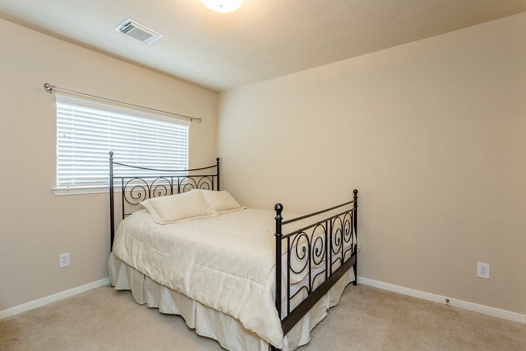 4530 Hall Croft Chase Lane, Katy, TX 77449 3rd bedroom neutral walls, and ample natural light from a large window.