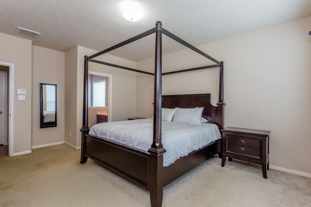 4530 Hall Croft Chase Lane, Katy, TX 77449 Master suite with neutral walls, and an ensuite bathroom.