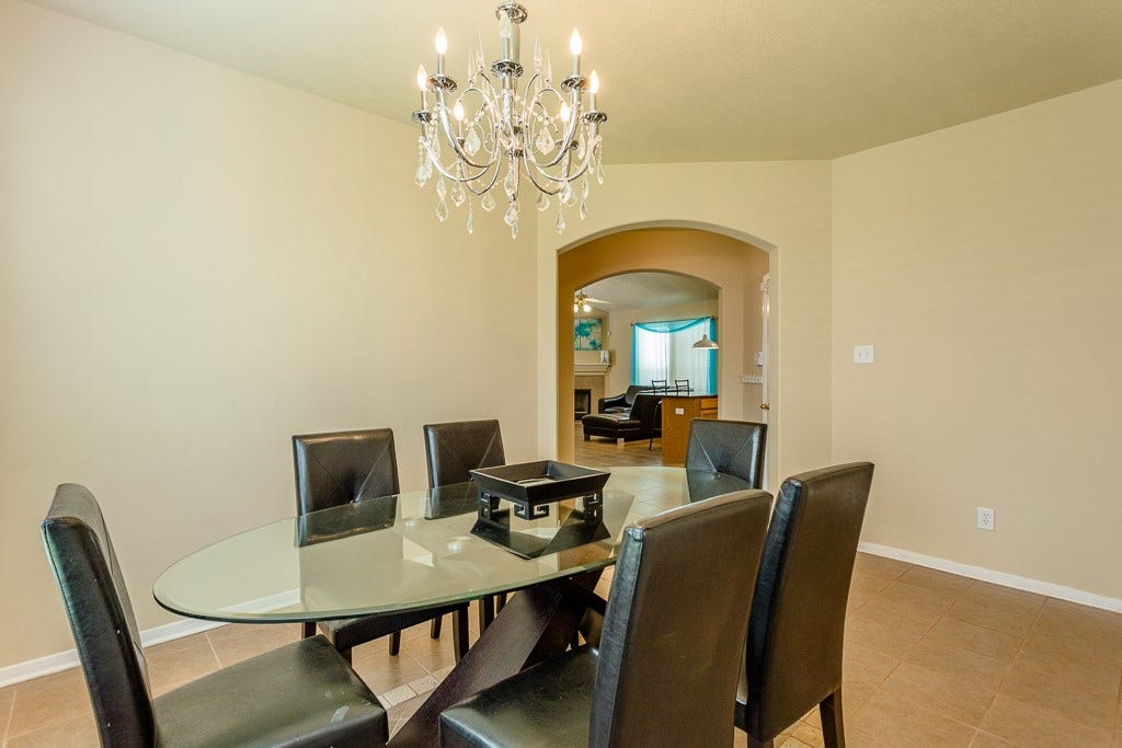4530 Hall Croft Chase Lane, Katy, TX 77449 Elegant dining area and an arched doorway leading to the cozy living space.