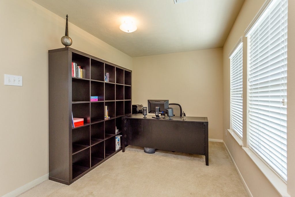 4530 Hall Croft Chase Lane, Katy, TX 77449 Bright home office featuring large windows, and ample space for productivity.