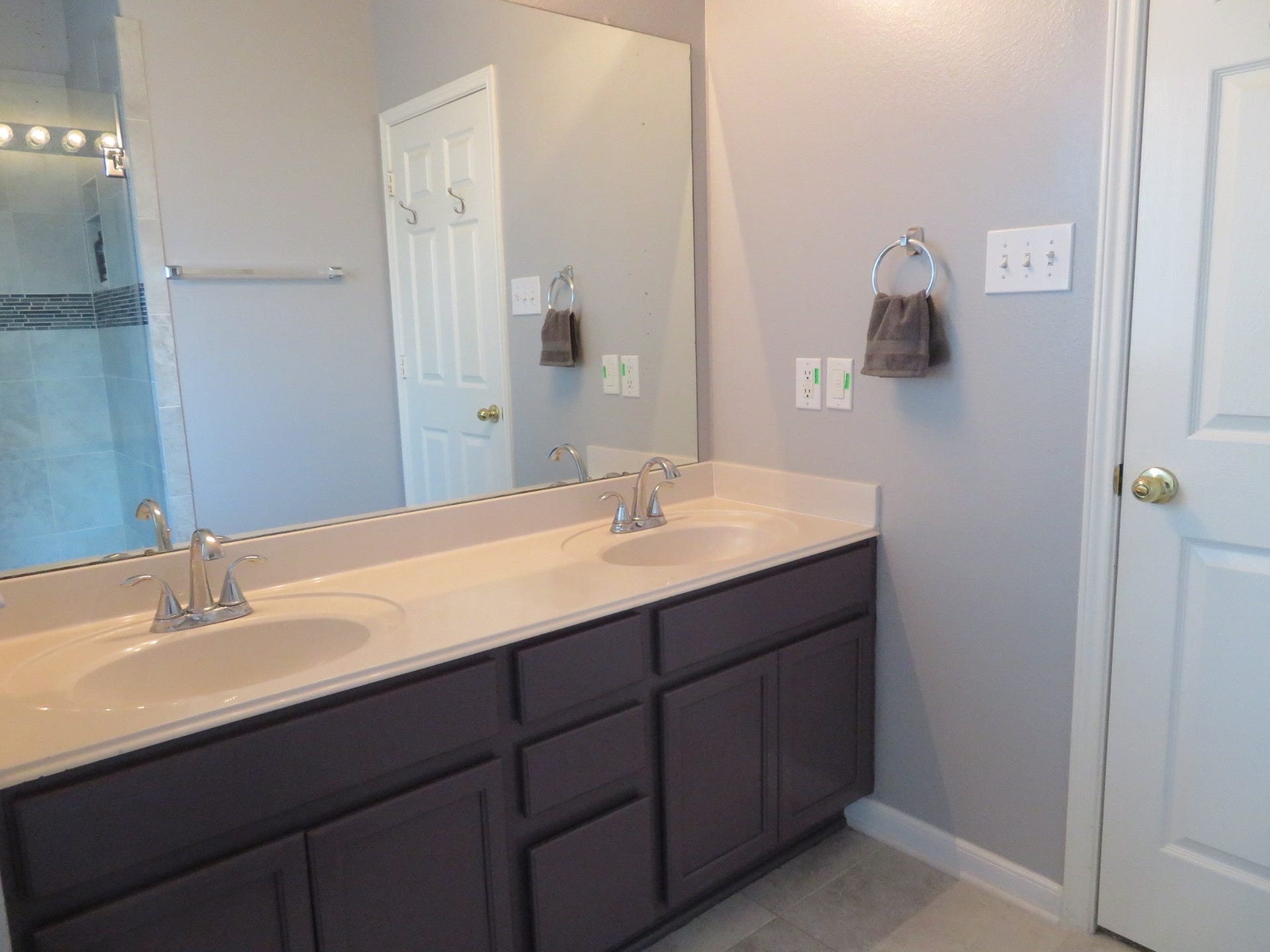 4530 Hall Croft Chase Lane, Katy, TX 77449 Elegant bathroom featuring a dual-sink vanity with modern fixtures, ample storage, and a sleek, seamless mirror.