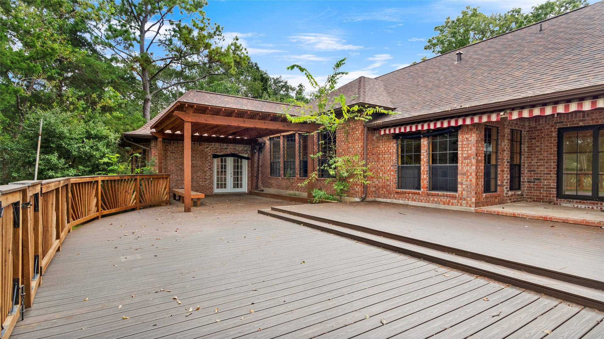 97 Avenue J, Dickinson, TX 77539 Covered patio and outdoor deck - this backyard is perfect for entertaining!