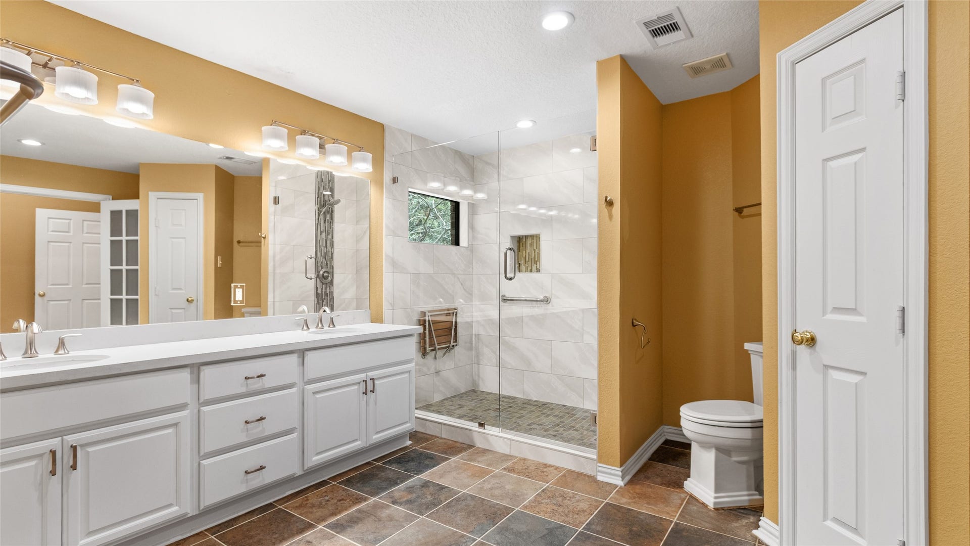 97 Avenue J, Dickinson, TX 77539 Primary bath has double vanities and walk in shower.