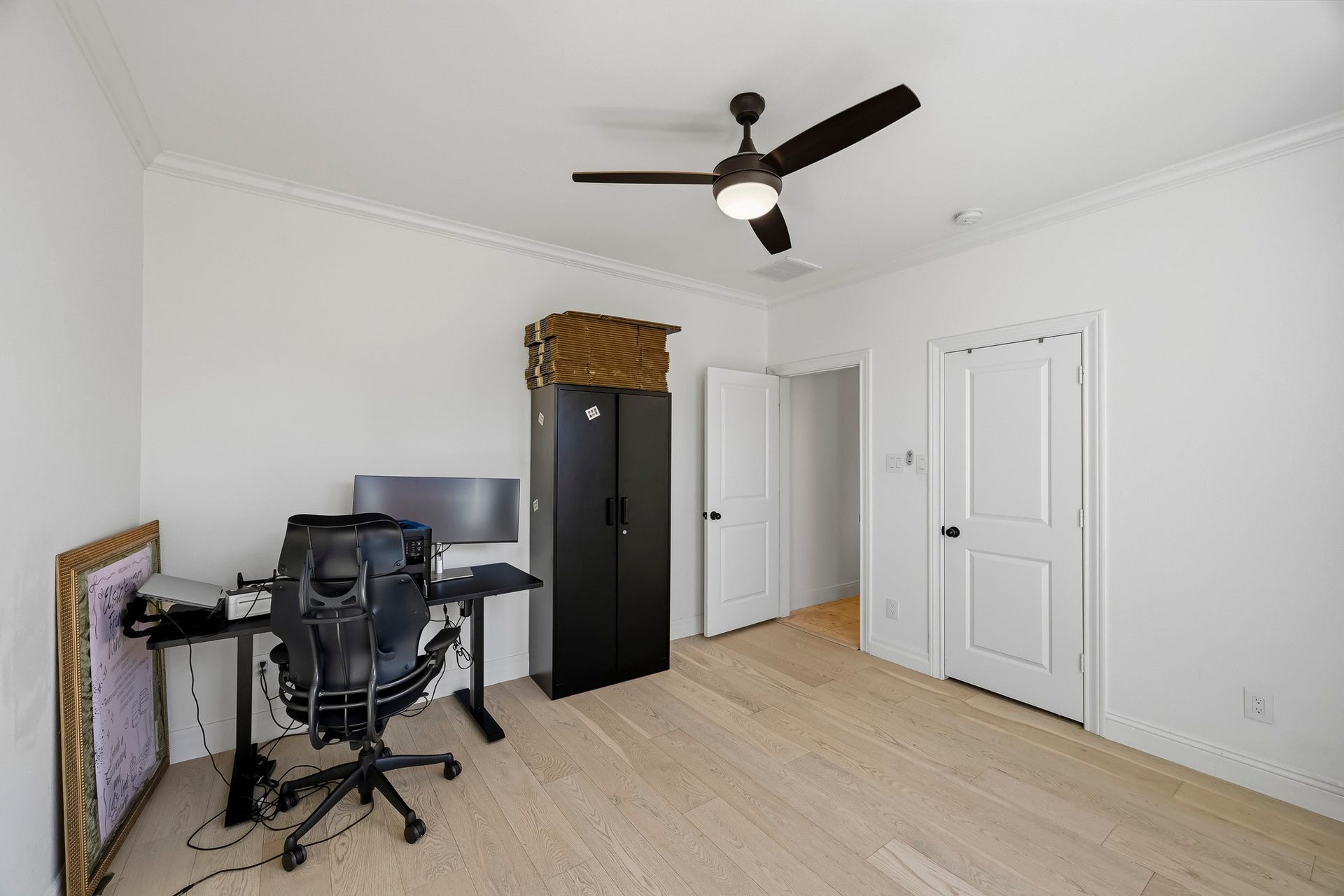 11009 Upland Forest Drive, Houston, TX 77043 Bright and spacious room with light wood flooring, and ample space for a home office setup.