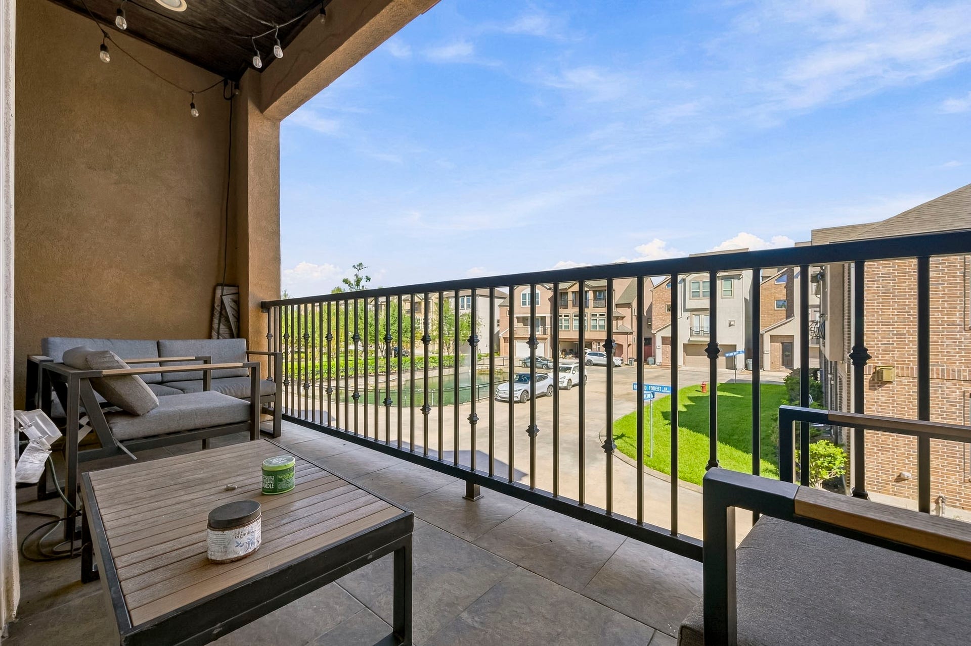 11009 Upland Forest Drive, Houston, TX 77043 Charming balcony offering a cozy seating area with stylish outdoor furniture, overlooking a serene neighborhood view. Perfect for relaxation and enjoying the fresh air.