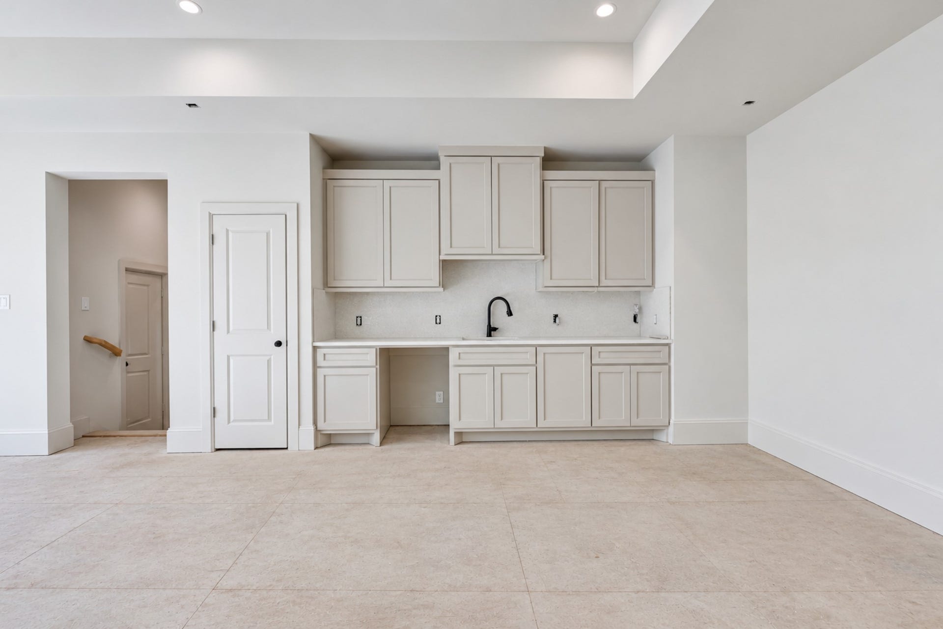 25083 Chisos Bend, Montgomery, TX 77316 The gossamer veil colored cabinetry pulls the tones from the calacatta counters and backsplash to tie the room together. Powder room located at the top of the stairs