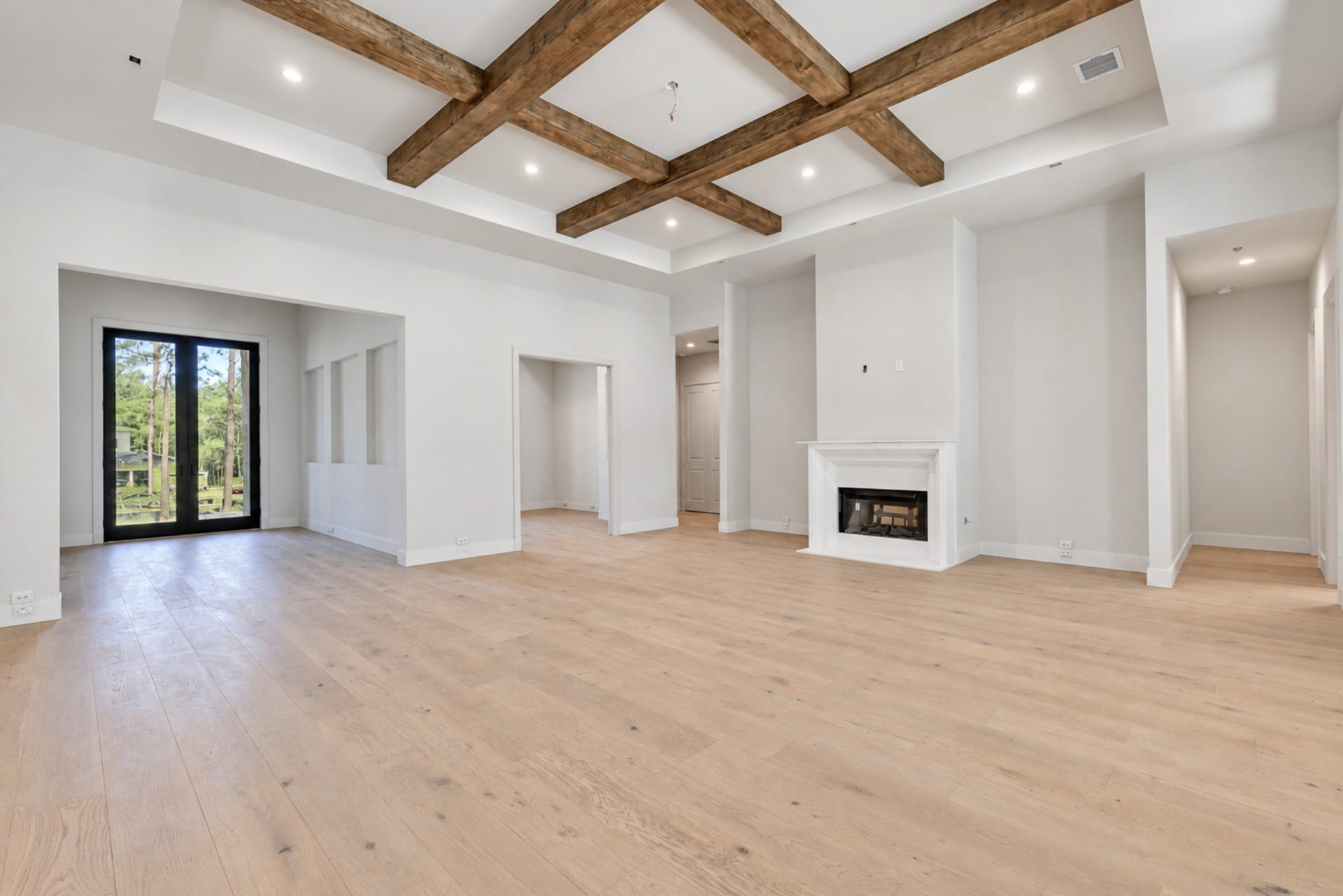25083 Chisos Bend, Montgomery, TX 77316 The family room features coffered ceilings and a stonecast fireplace