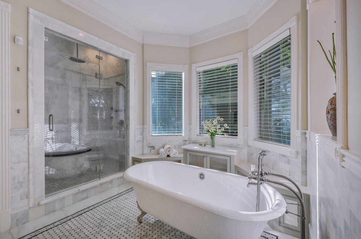 35 W Isle Place, The Woodlands, TX 77381 Spa-inspired primary bathroom featuring a soaking tub, walk-in shower, and oversized windows