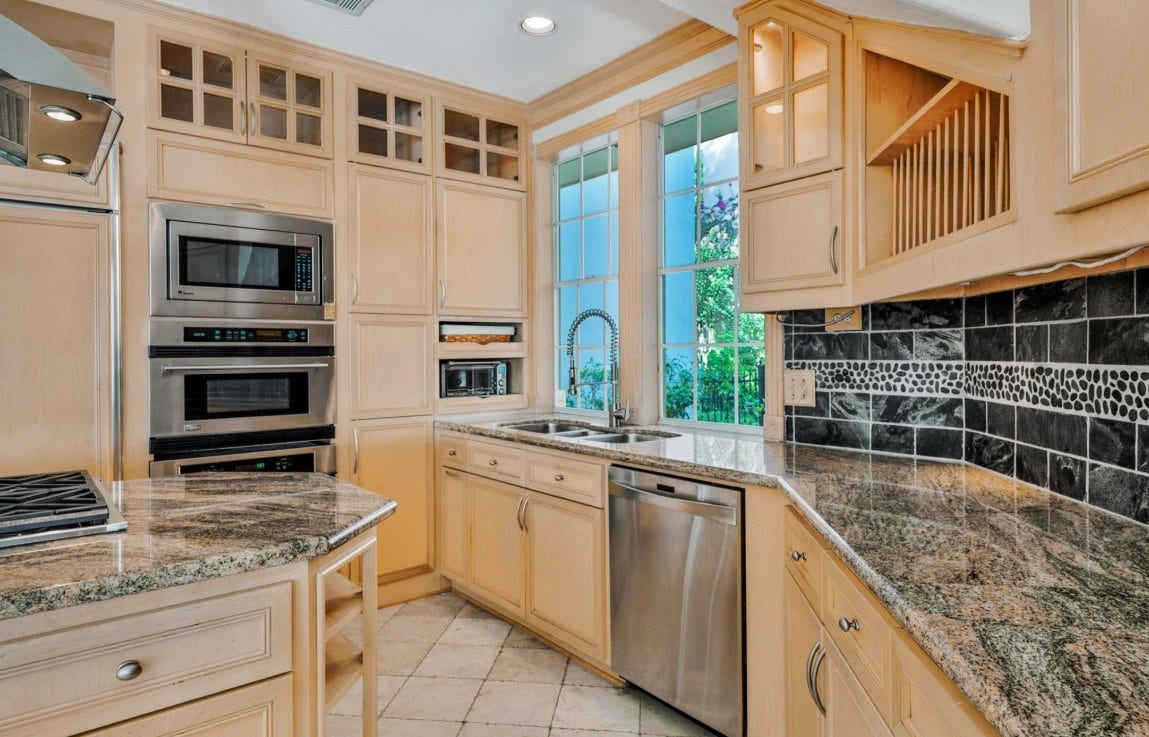 35 W Isle Place, The Woodlands, TX 77381 Chef's kitchen with ovens, extensive cabinetry, granite countertops, and natural light