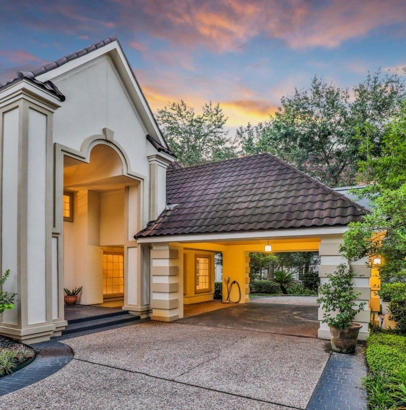 35 W Isle Place, The Woodlands, TX 77381 Covered front entry with elegant architectural details and spacious three-car garage.