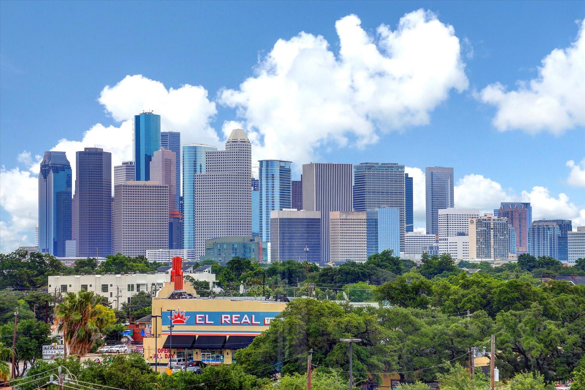 1111 Caroline Street, #2601, Houston, TX 77010 Houston skyline view provides broader city context for this downtown address. Towers and green spaces illustrate the surrounding urban landscape rather than a view from Unit 2601.