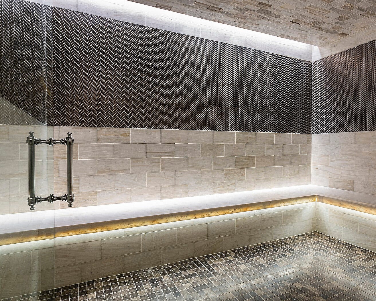 1111 Caroline Street, #2601, Houston, TX 77010 Tiled spa room features contrasting wall finishes, mosaic flooring and concealed lighting. Wellness space is part of the hotel's spa facilities.