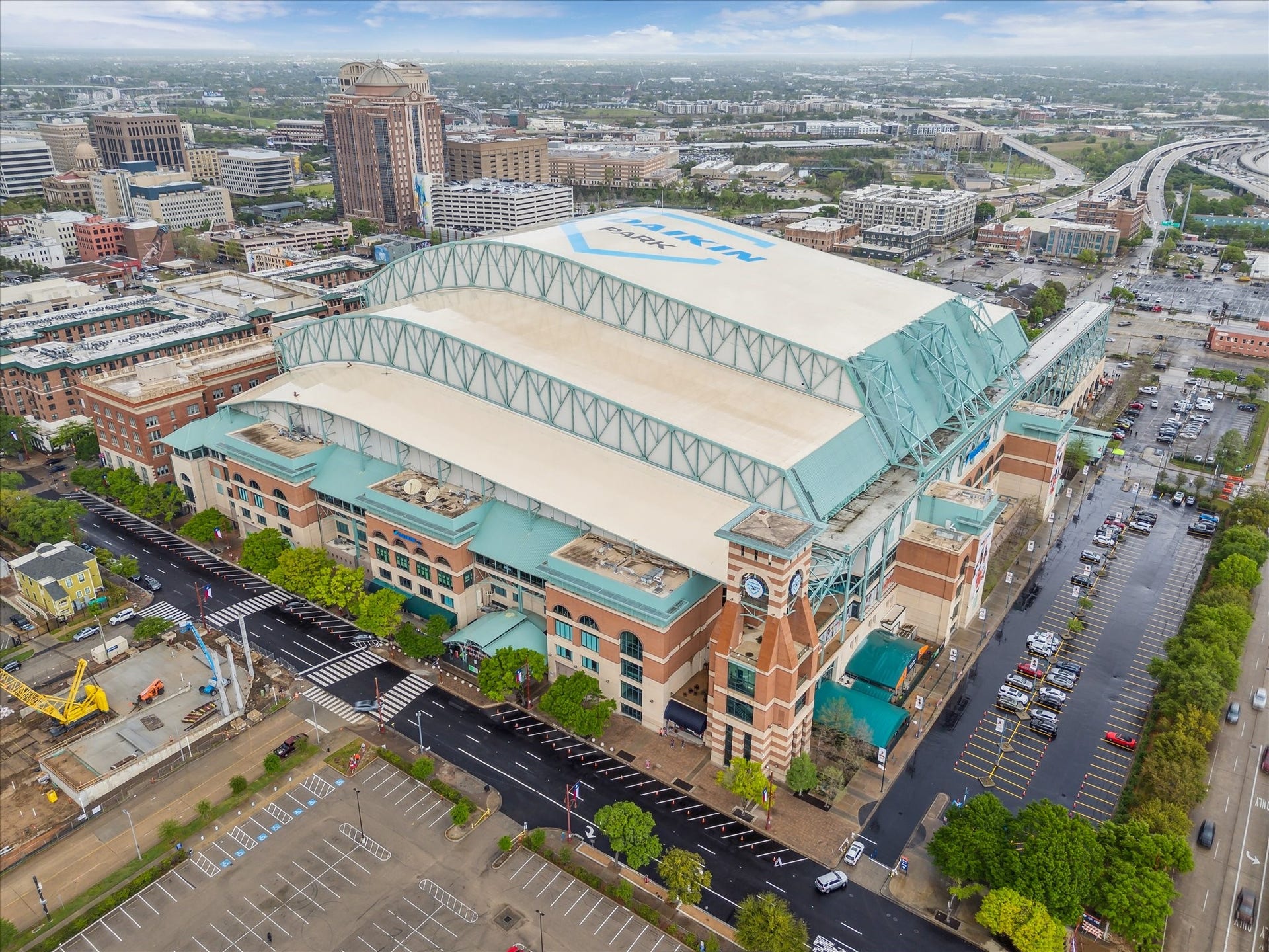 1111 Caroline Street, #2601, Houston, TX 77010 Ballpark aerial shows the retractable roof and surrounding downtown street grid. Sports destination is pictured as part of the neighborhood, rather than as a view from Unit 2601.