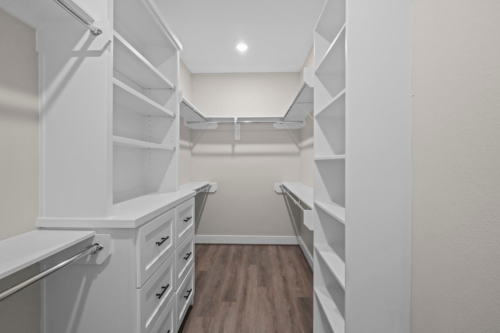 2412 Terry Street, #A, Houston, TX 77009 Designed for optimal wardrobe storage, this primary closet offers built-in chest-of-drawers, overhead shelving, and multi-tier hanging space.