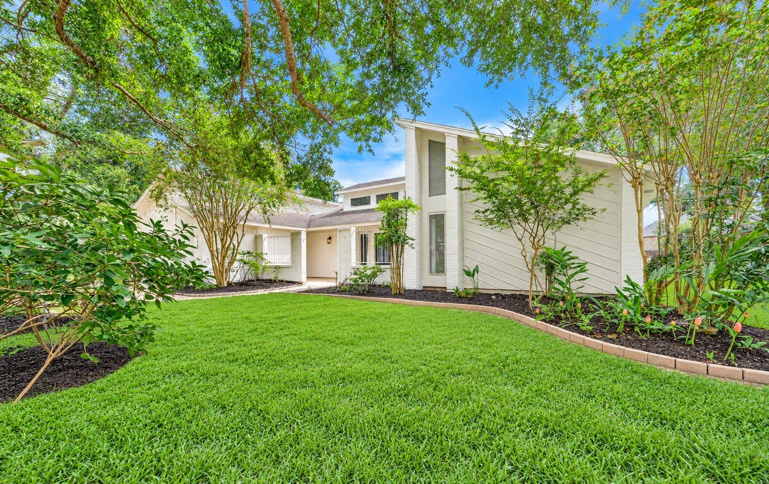 109 Dorado Drive, Friendswood, TX 77546 Beautiful front elevation surrounded by mature trees and landscaping.
