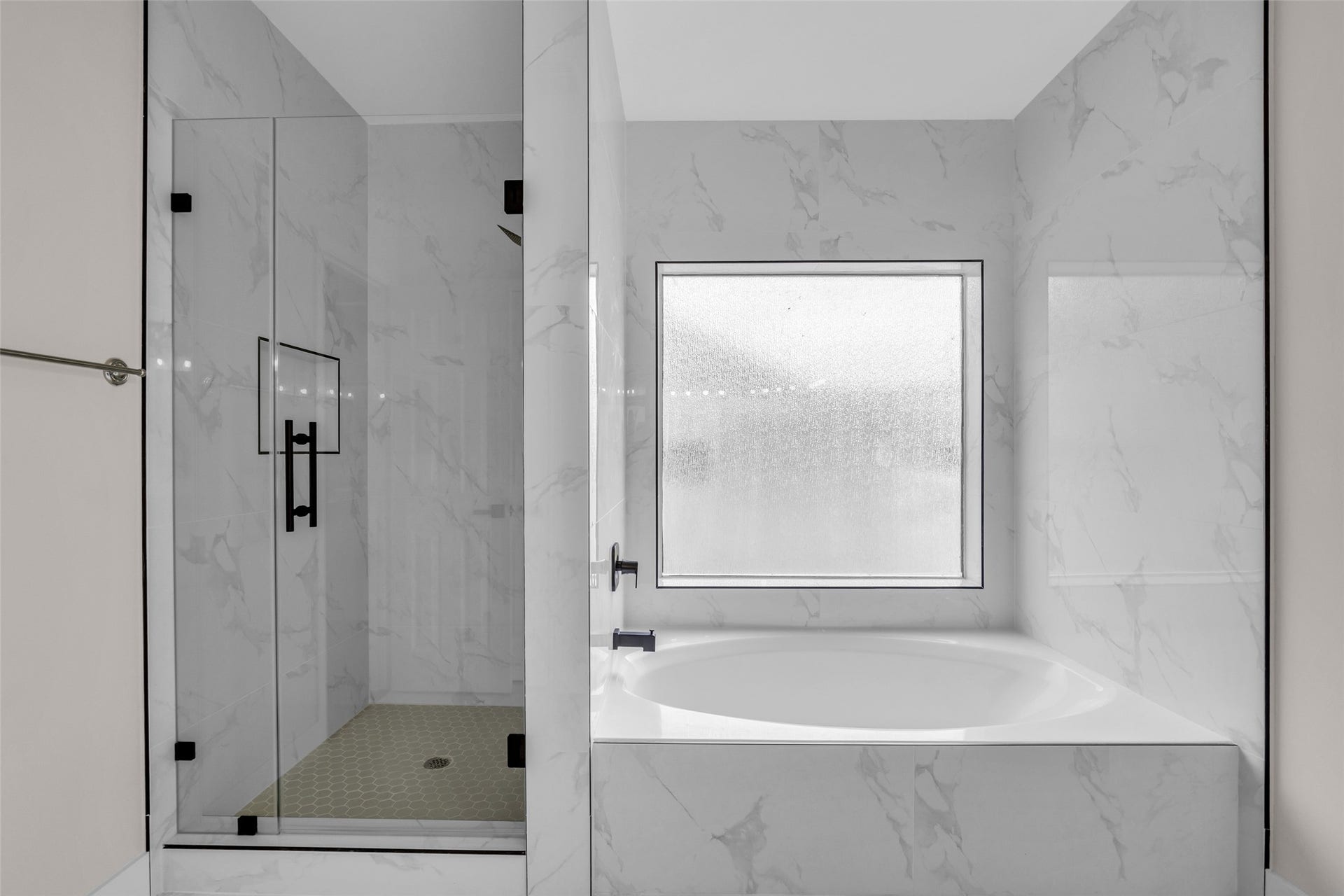 22002 Madera Canyon Court, Richmond, TX 77469 primary bath featuring a sleek glass door shower, paired with a soaking tub and sophisticated finishes.