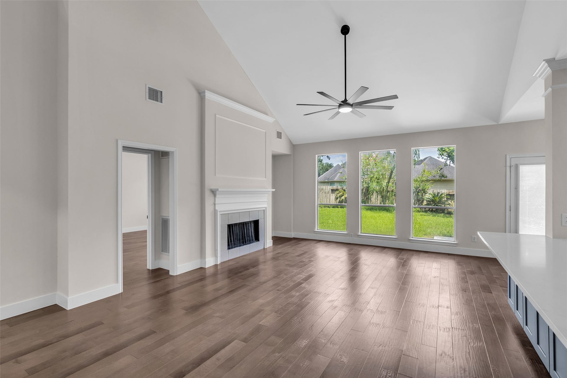 22002 Madera Canyon Court, Richmond, TX 77469 Discover your expansive living room, where abundant natural light flows through large windows, highlighting engineered wood floors and a cozy fireplace...