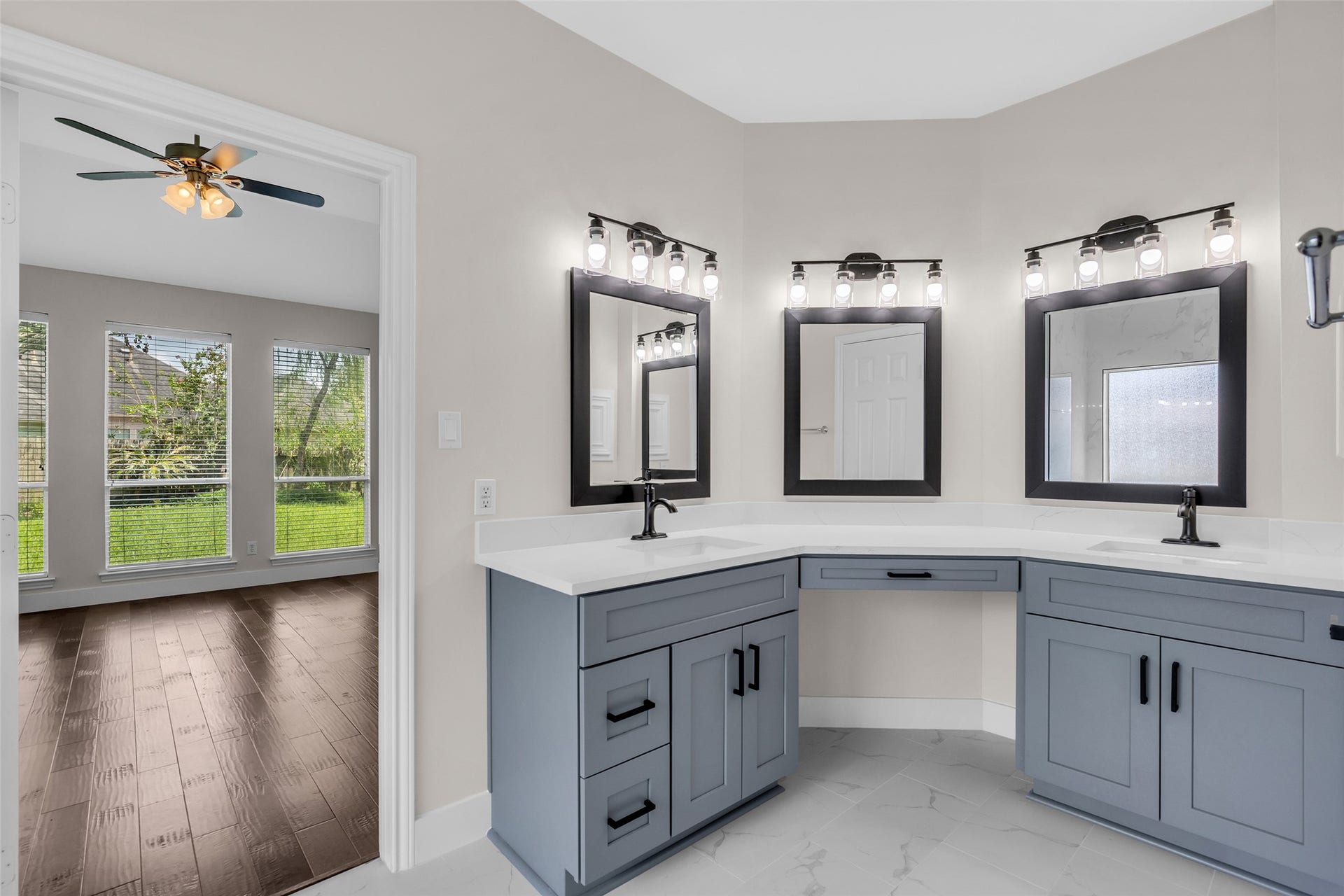 22002 Madera Canyon Court, Richmond, TX 77469 Fully remodeled primary bath with marble tiling, matte black lighting fixtures and faucets